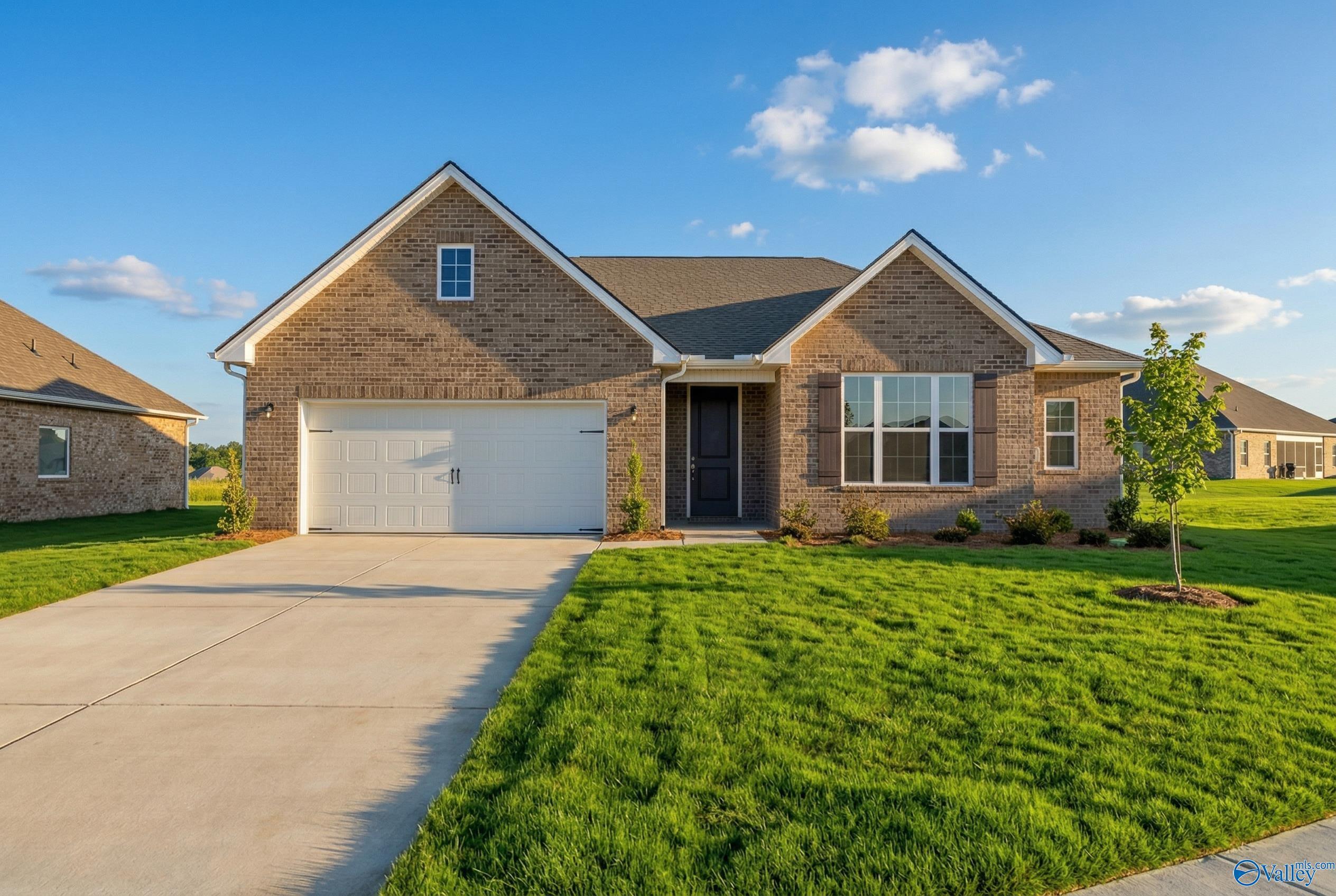 Brick ranch home with gabled roof, 2-car garage, and manicured lawn in Pikes Ridge, Meridianville, Alabama by Davidson Homes