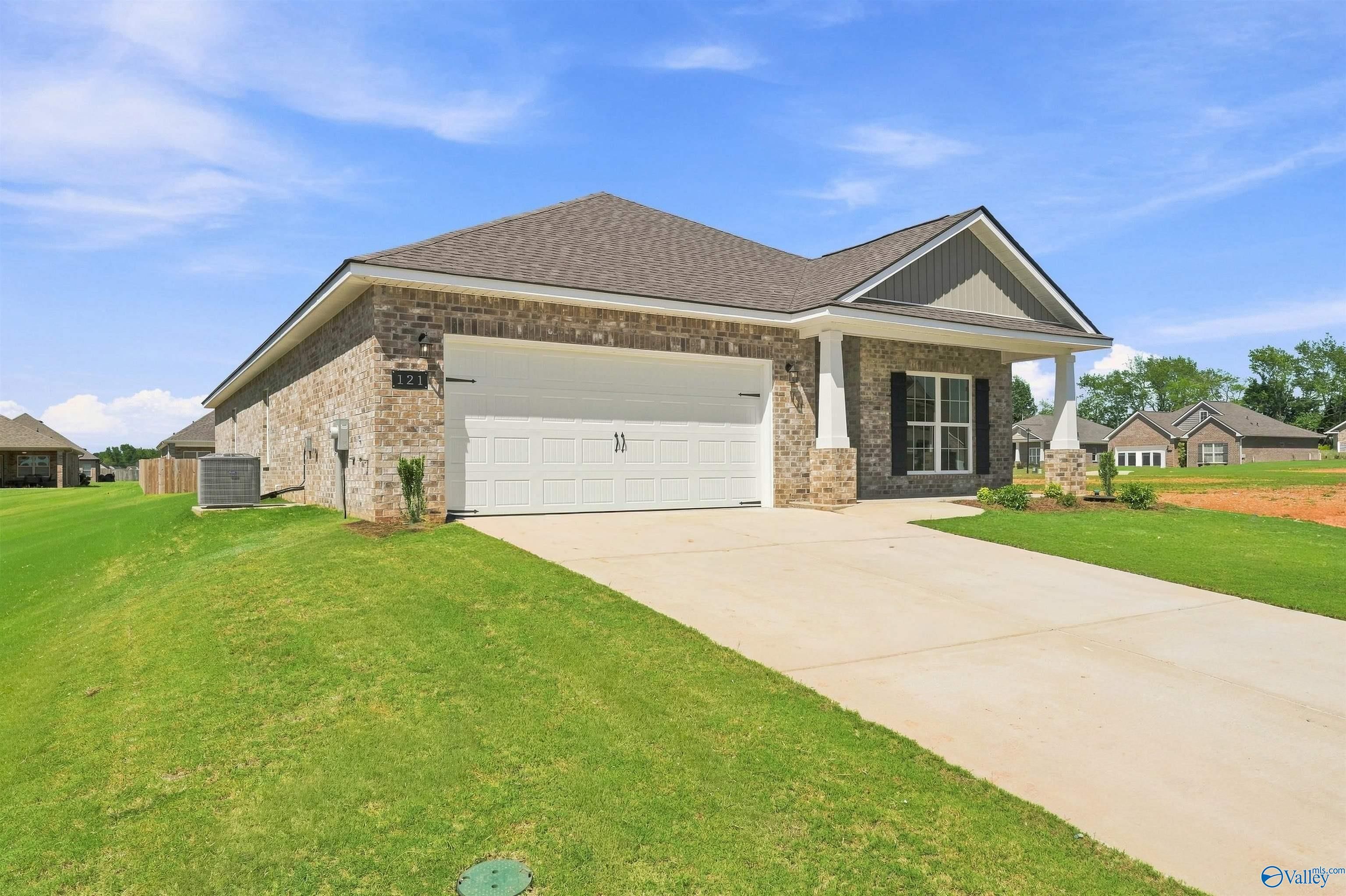 Brick exterior of The Everett B floor plan by Davidson Homes with a 2-car garage in Ivy Hills, Toney, Alabama.