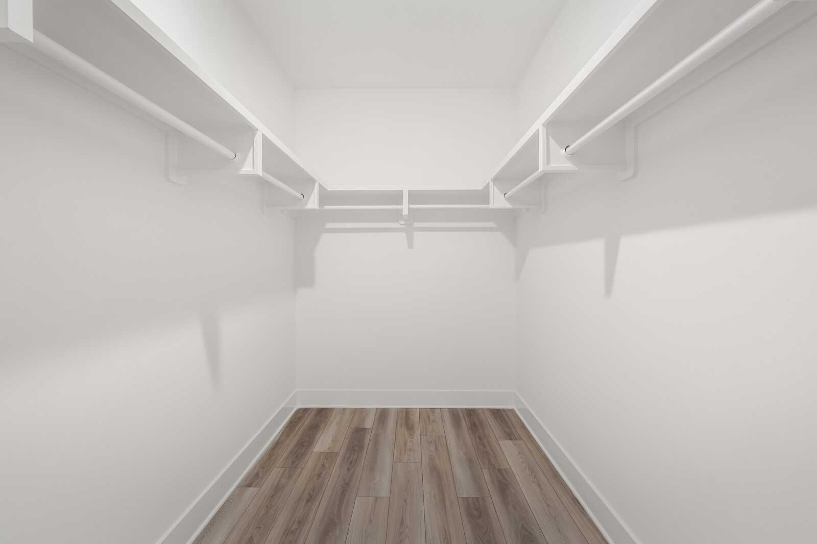 Spacious walk-in closet with white shelving and hardwood floors in Davidson Homes The Hathaway, Murfreesboro, Tennessee
