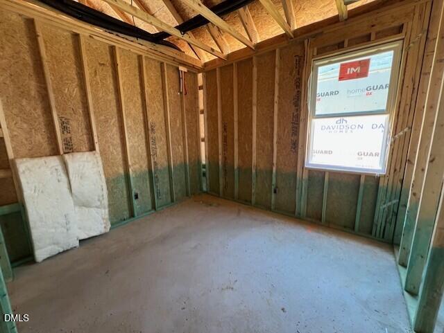 Unfinished bedroom interior with wood framing and window installation in The Carter A floor plan, Lillington, NC.