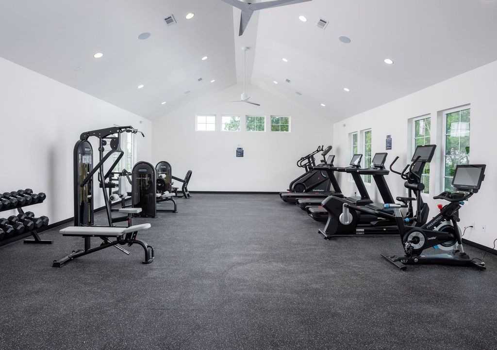 Modern fitness center with treadmills, ellipticals, weight machines, and dumbbells in Shelton Square, Murfreesboro, Tennessee