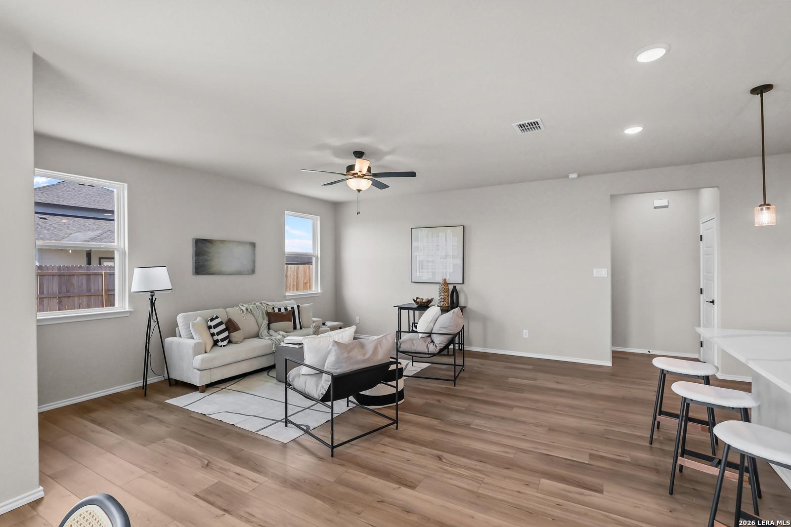Bright, open-concept living room with modern furniture in The Daphne H floor plan at Hannah Heights, Seguin, Texas.