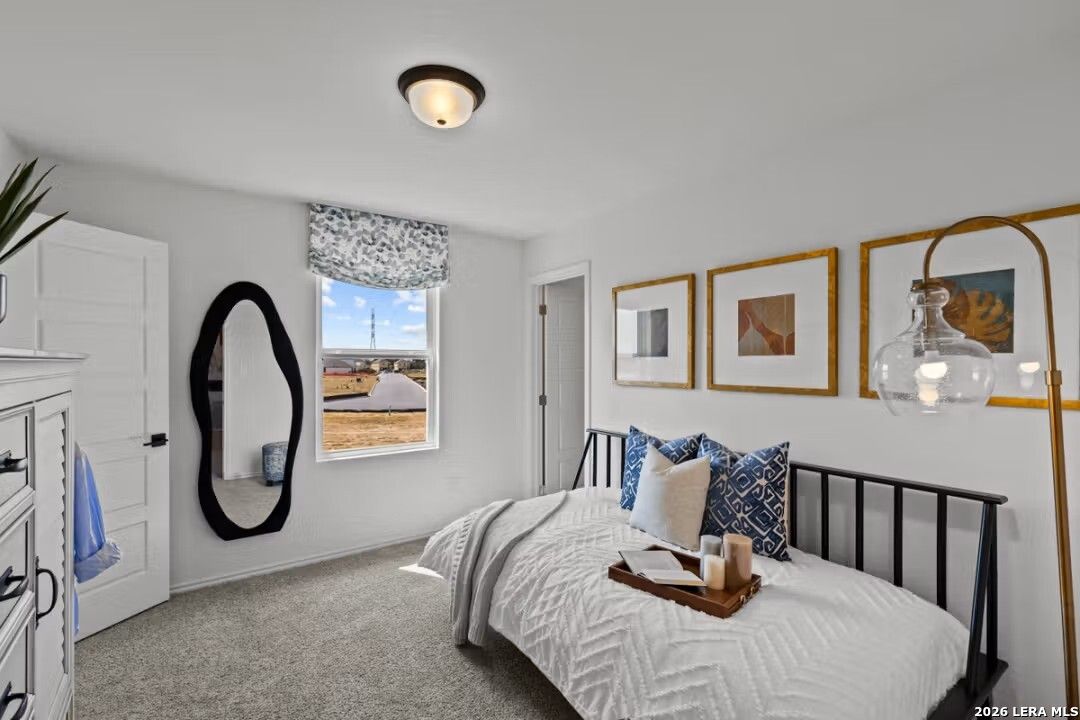Cozy secondary bedroom with twin bed, modern art, and window view in Davidson Homes The Douglas C, Converse, Texas