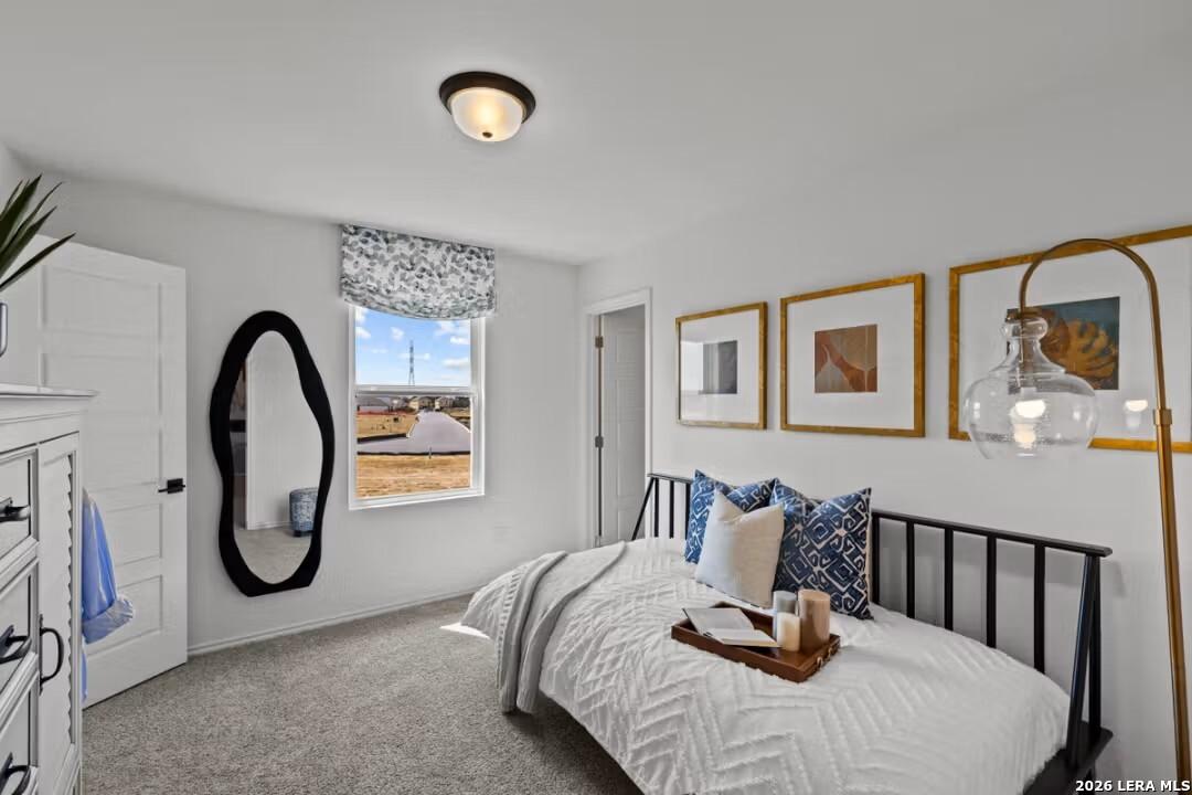 Cozy secondary bedroom with twin bed, modern art, and window view in Davidson Homes The Douglas C, Converse, Texas