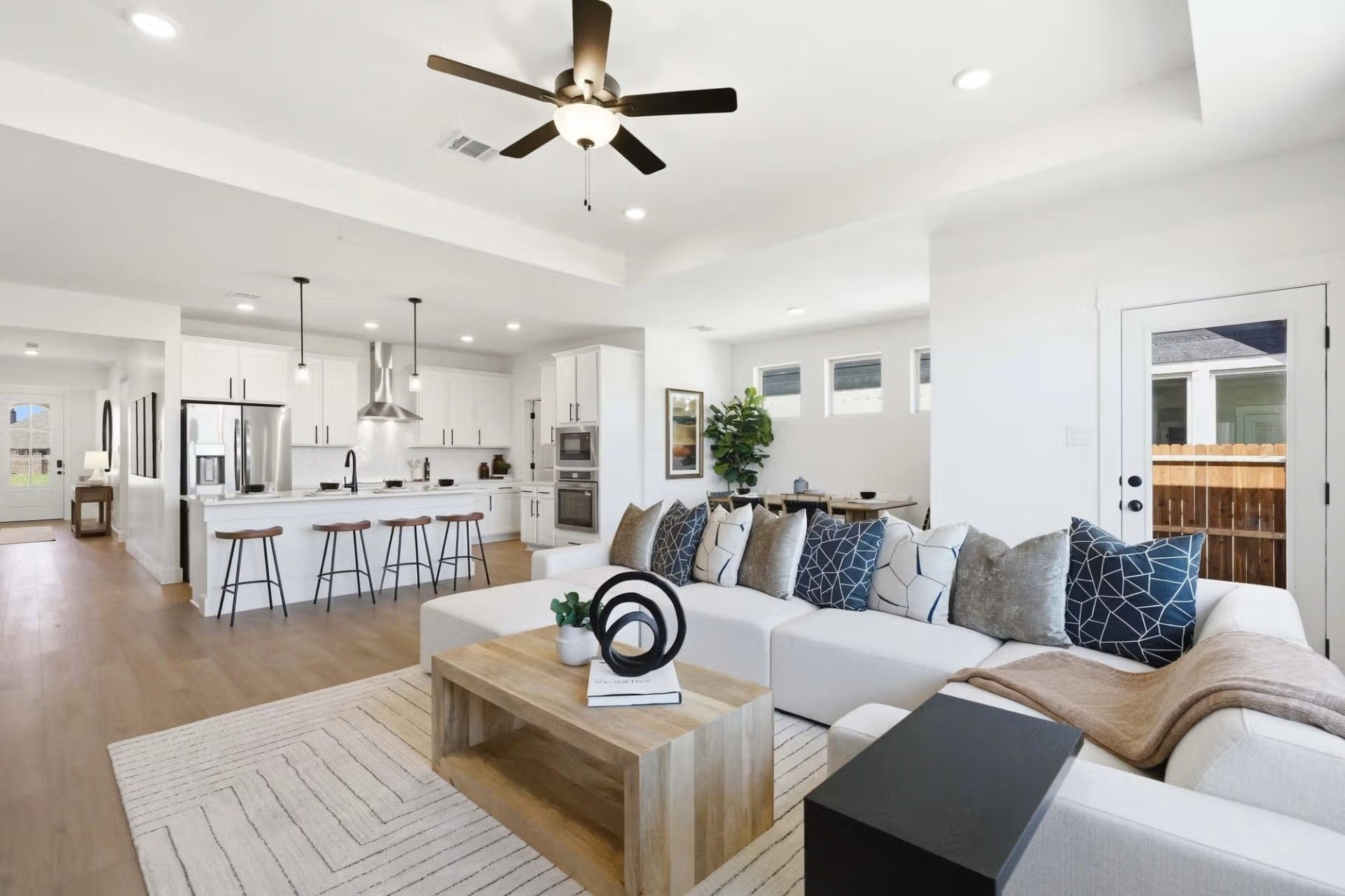 Open-concept living room and kitchen in The Laurel O floor plan by Davidson Homes in Mercer Meadows, Royse City, Texas.