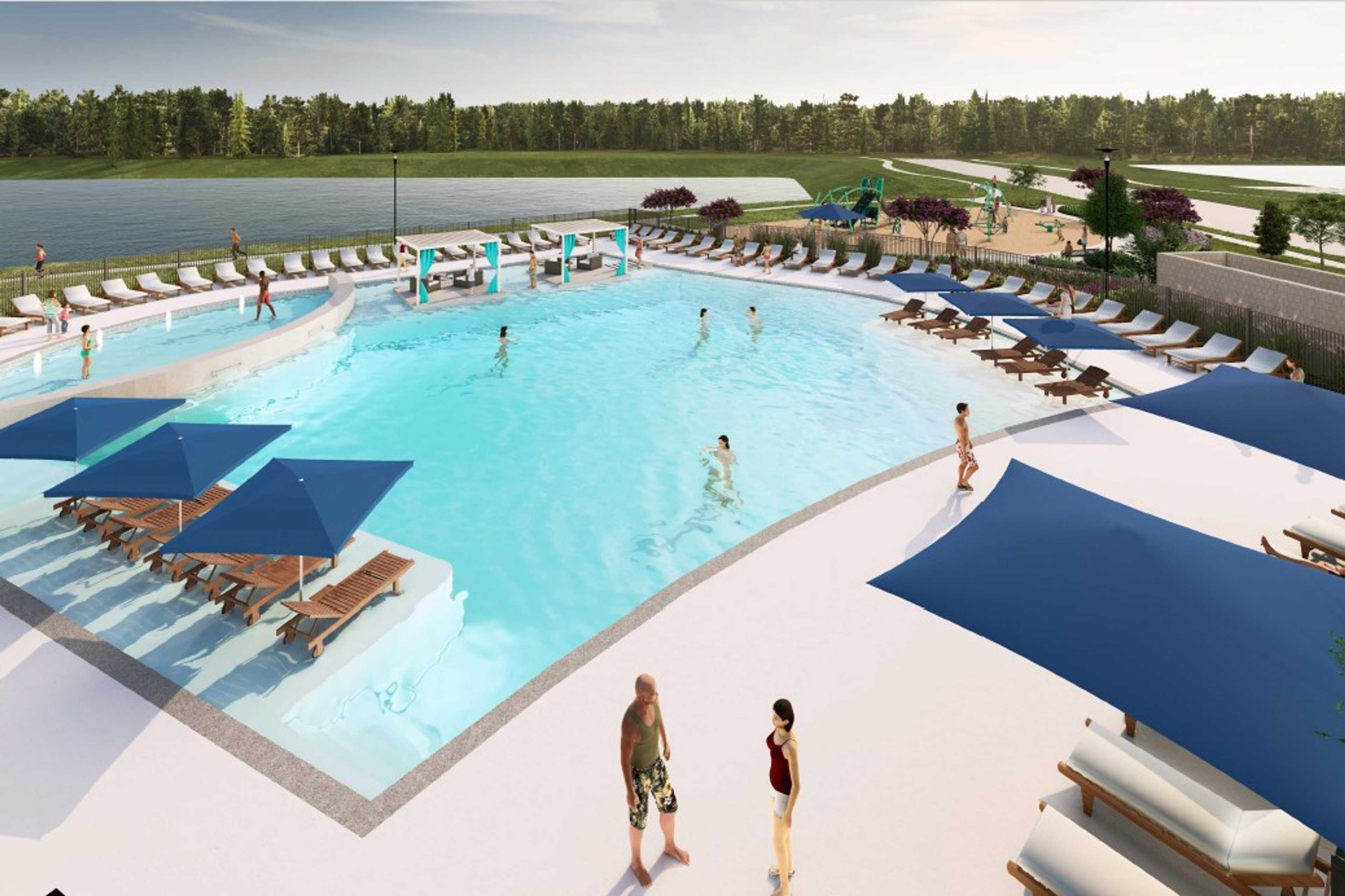 Resort-style lagoon pool at Sundance Cove in Crosby Texas with zero-entry beach blue umbrellas and lounge chairs