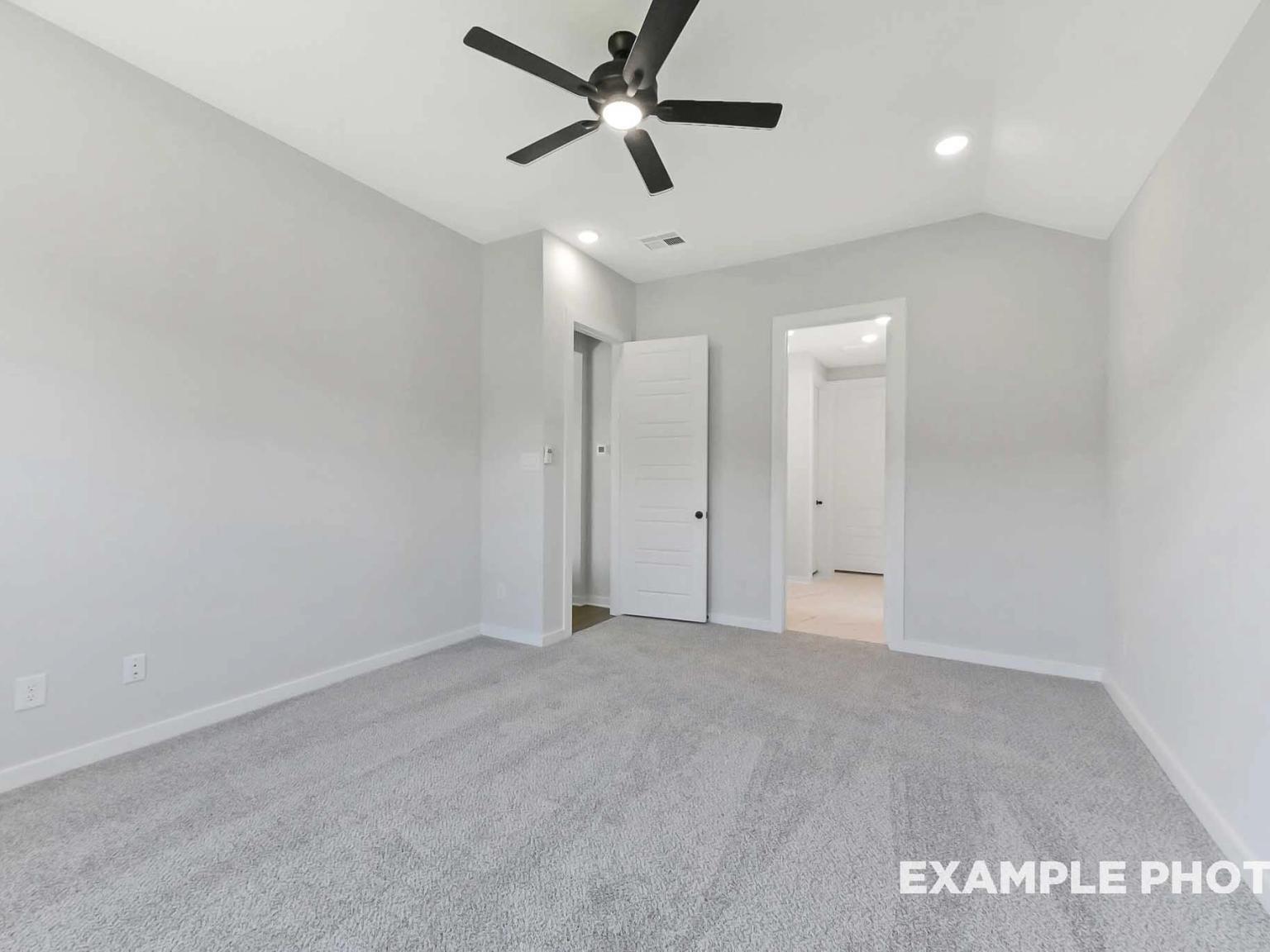 Spacious bedroom with vaulted ceiling and ceiling fan in The Sequoia C floor plan at Sundance Cove, Crosby, Texas.