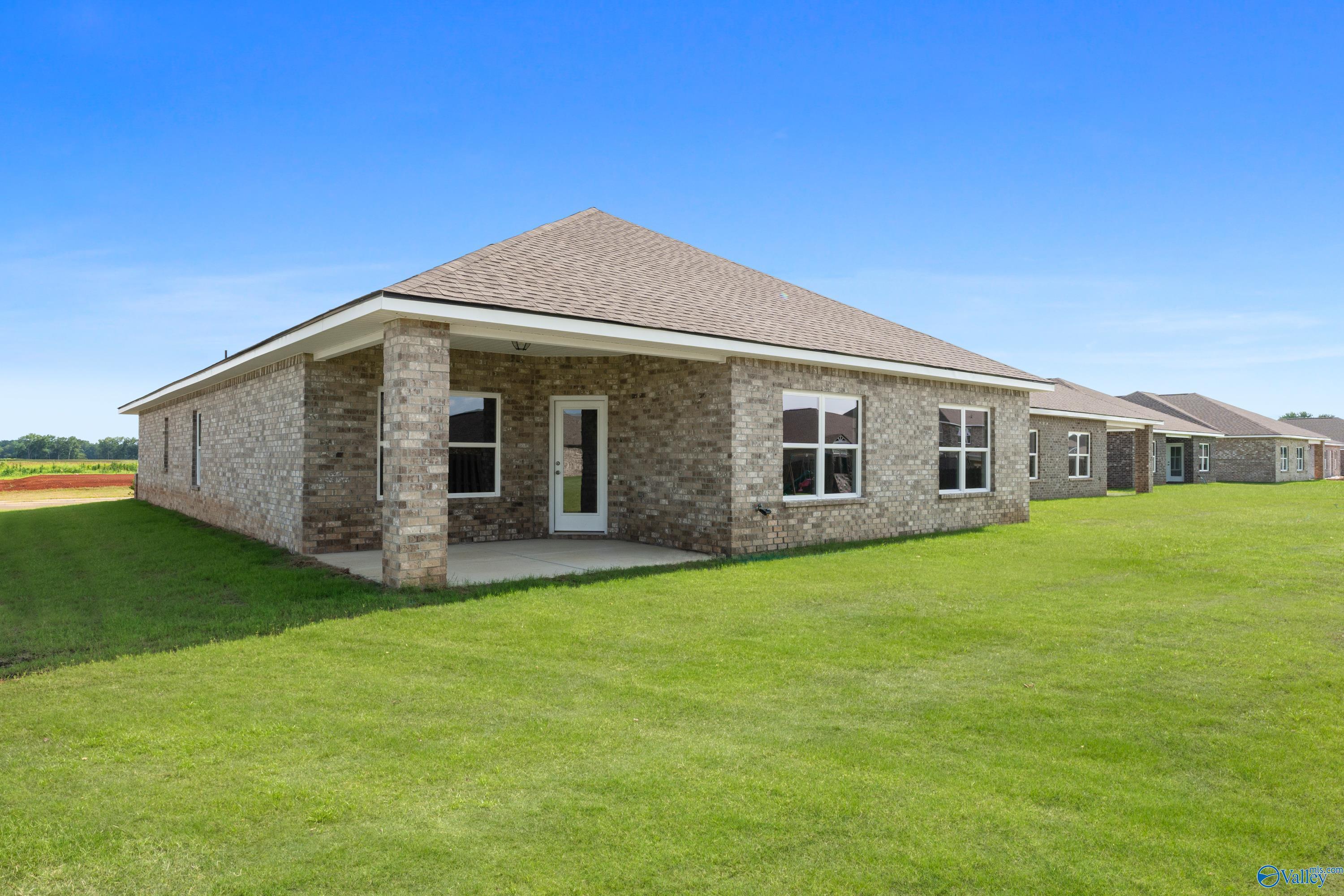 Brick single-story Everett B home by Davidson Homes in Ivy Hills, Toney, Alabama, with gabled roof, covered porch and green lawn
