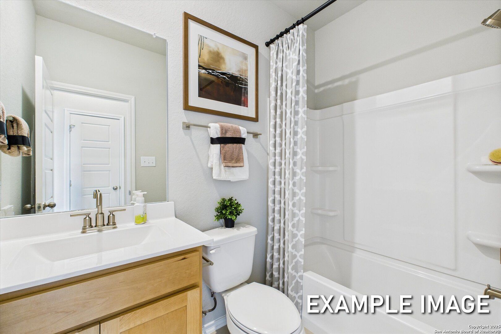 Modern bathroom featuring oak vanity, white subway tile shower, tub, and neutral decor in Davidson Homes The Sabine C, Agave, San Antonio