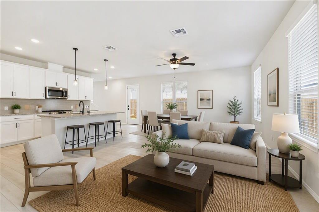 Bright open-concept living room and kitchen with white cabinetry in Davidson Homes The Charlotte B, Greene Farm, Cartersville, Georgia