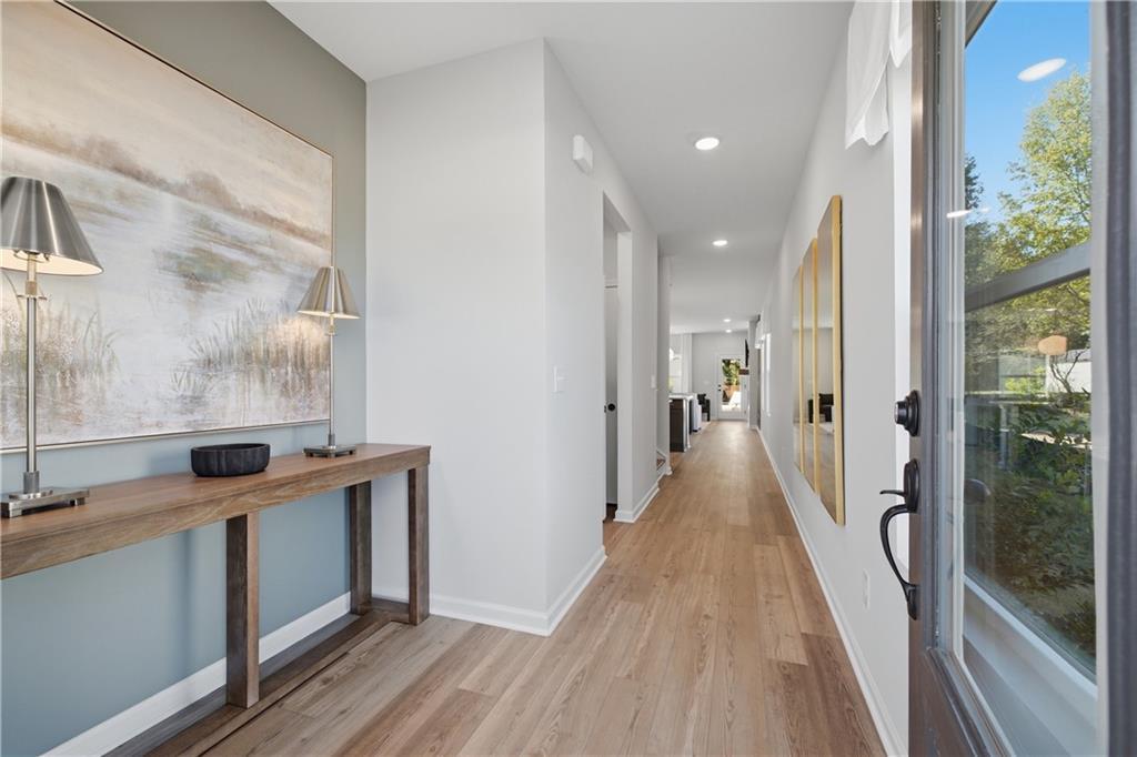 Bright foyer with hardwood floors, console table, and wall art in Davidson Homes' The Sinclair B at Greene Farm, Cartersville, GA