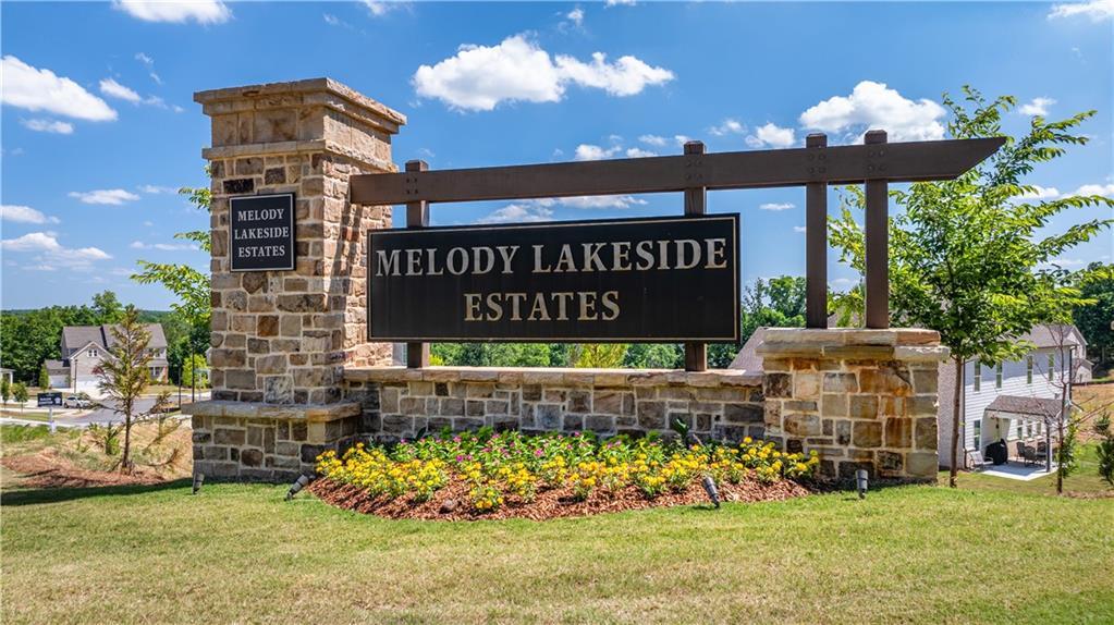 Stone entrance sign with landscaping at Melody Lakeside Estates, Davidson Homes community in Buford, Georgia