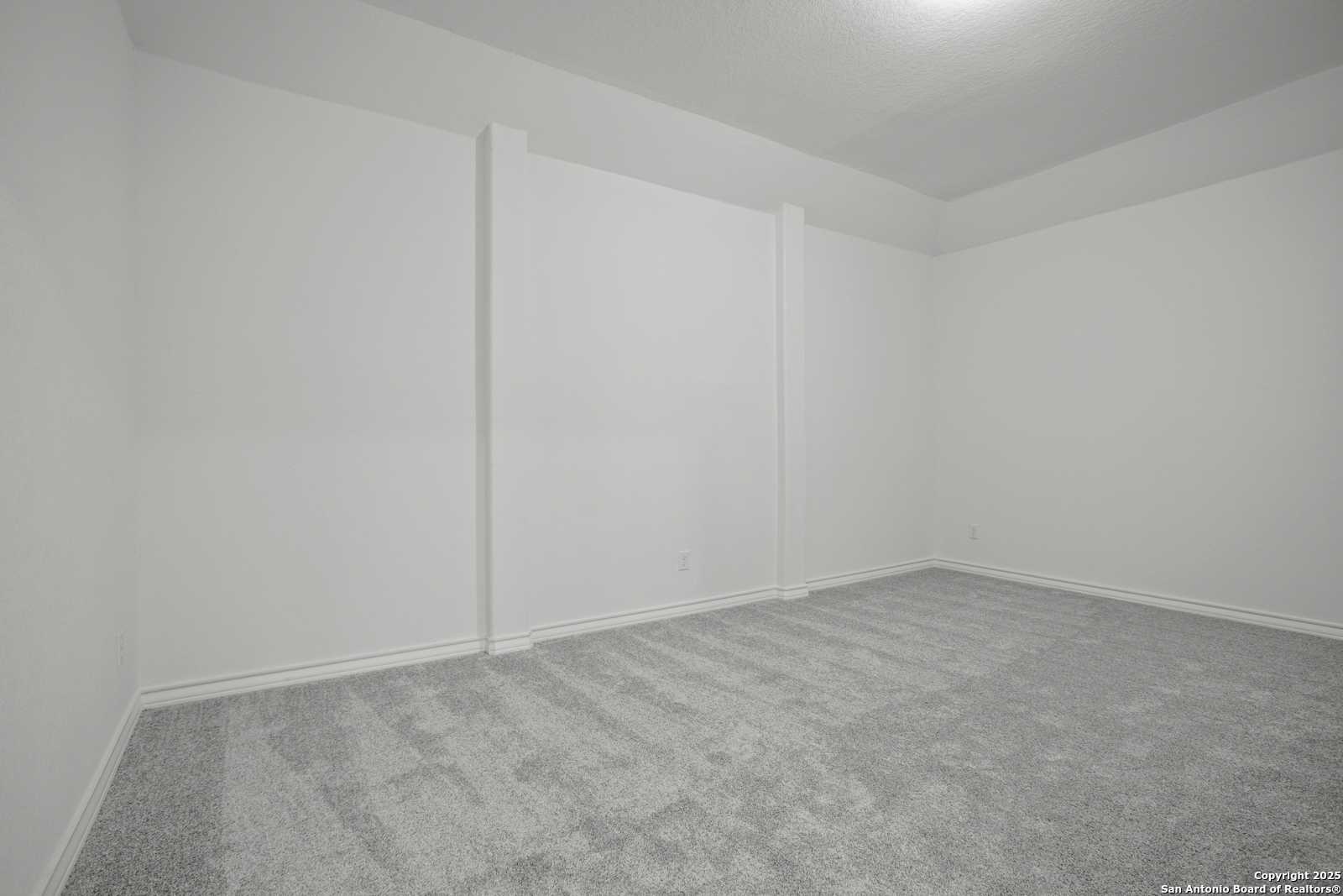 Empty bedroom featuring white walls, gray carpet, and recessed ceiling light in Davidson Homes Summerlin B, Castroville, Texas