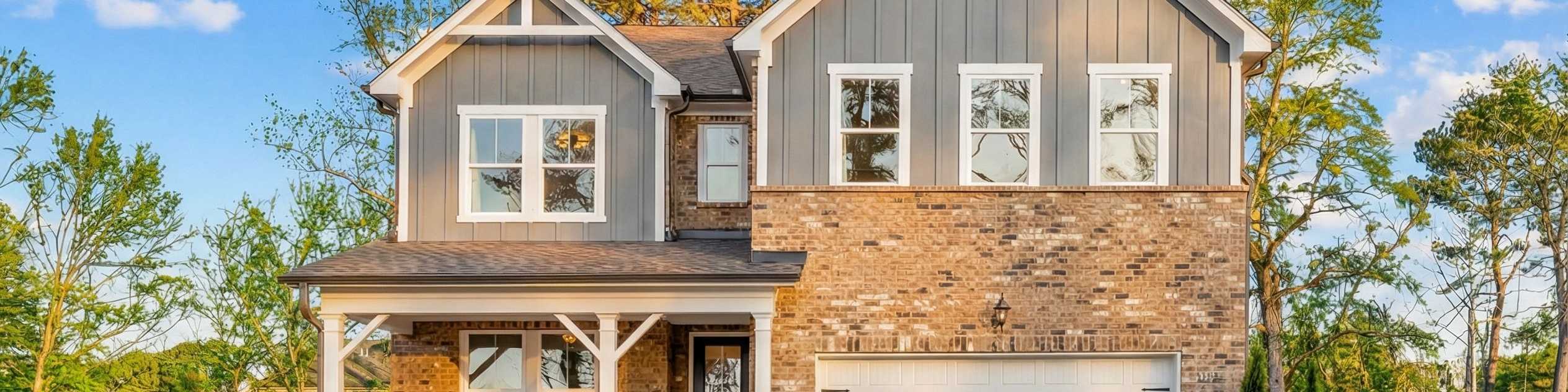 Two-story home exterior at Fern Hollow in Buford, Georgia, built by Davidson Homes with brick facade and covered front porch.