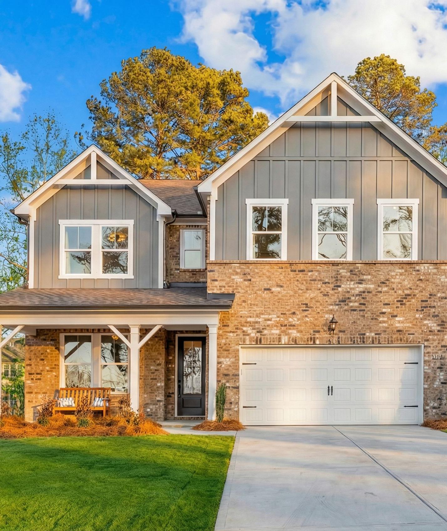 Two-story home exterior at Fern Hollow in Buford, Georgia, built by Davidson Homes with brick facade and covered front porch.