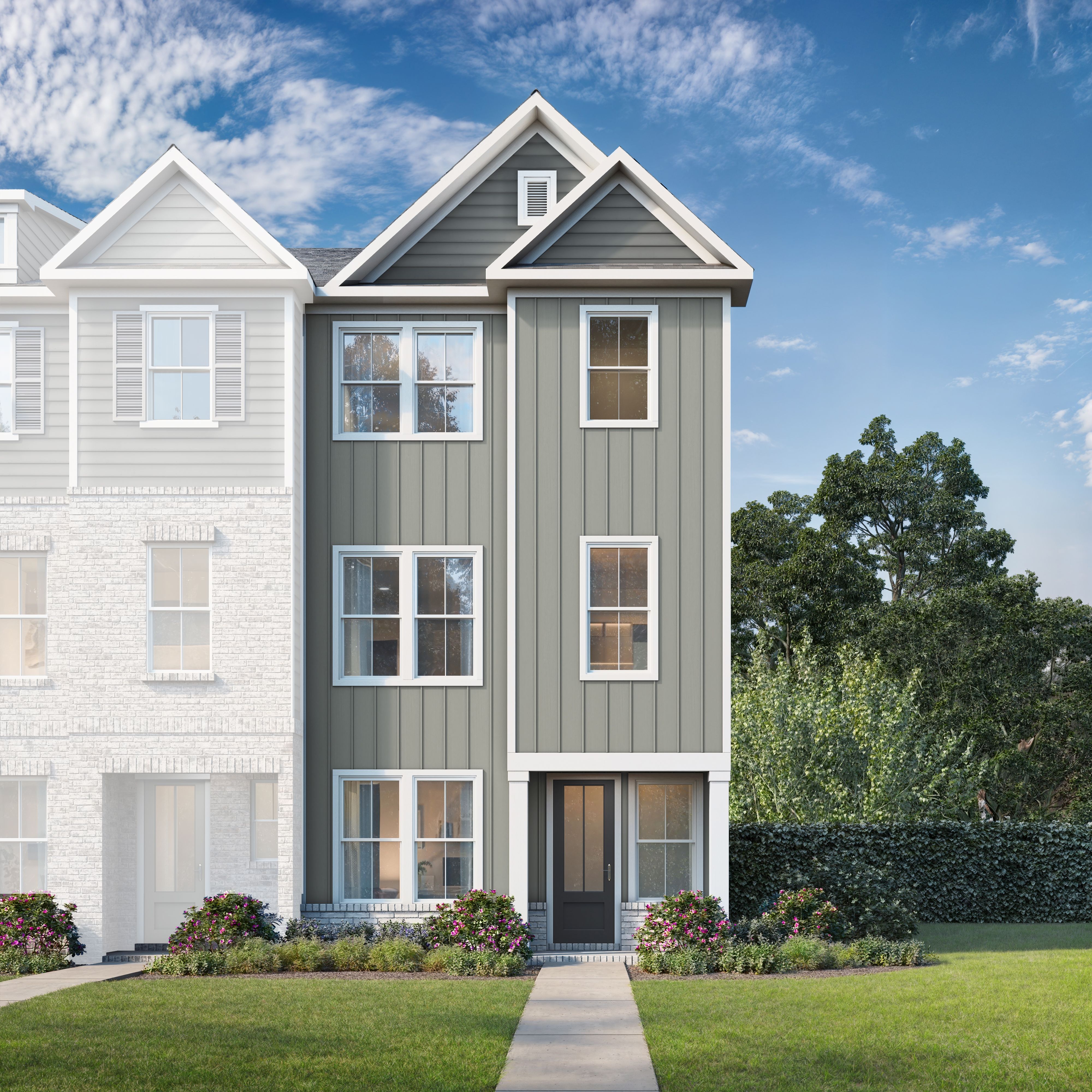 Three-story multi-family townhome elevation of The Lincoln B featuring gray siding, white brick accents, windows, and landscaped front yard in Woodstock GA