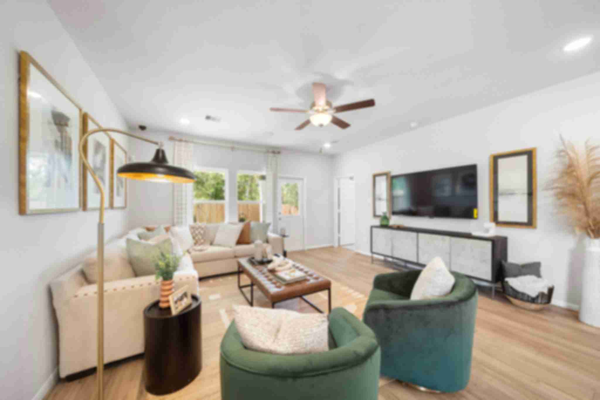 Modern open-concept living room at Caney Creek Place in Conroe Texas with beige sofa