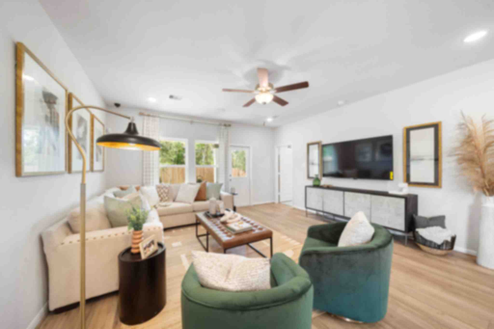 Modern open-concept living room at Caney Creek Place in Conroe Texas with beige sofa