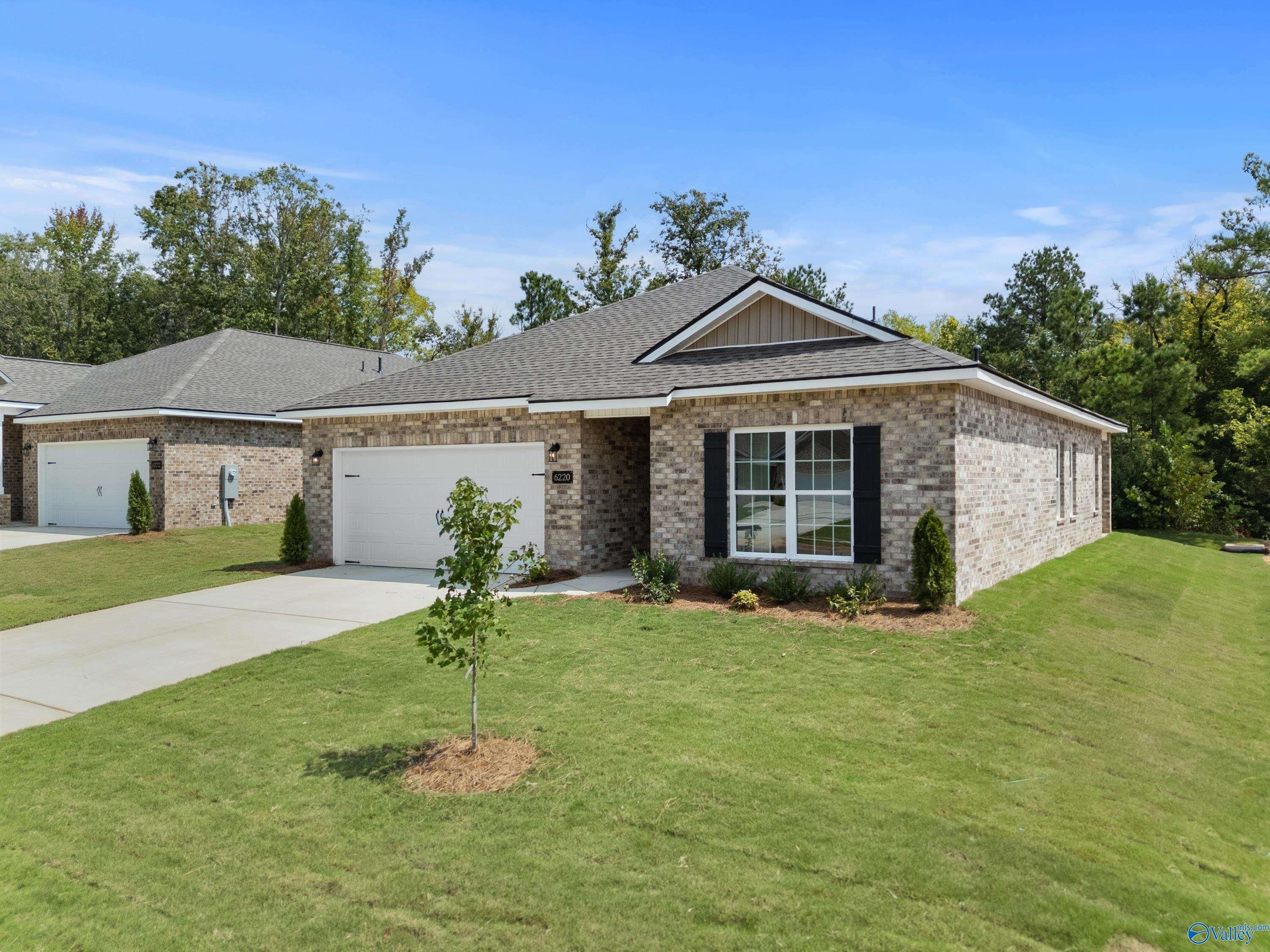 Modern brick single-story home with 2-car garage and driveway in Spragins Cove, Huntsville, Alabama by Davidson Homes The Franklin