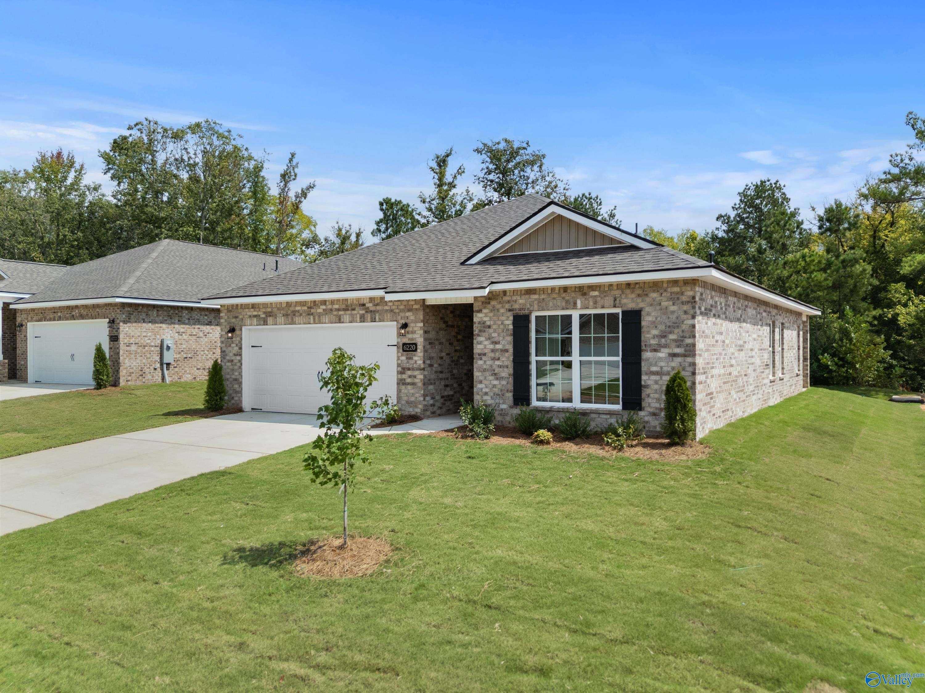 Modern brick single-story home with 2-car garage and driveway in Spragins Cove, Huntsville, Alabama by Davidson Homes The Franklin