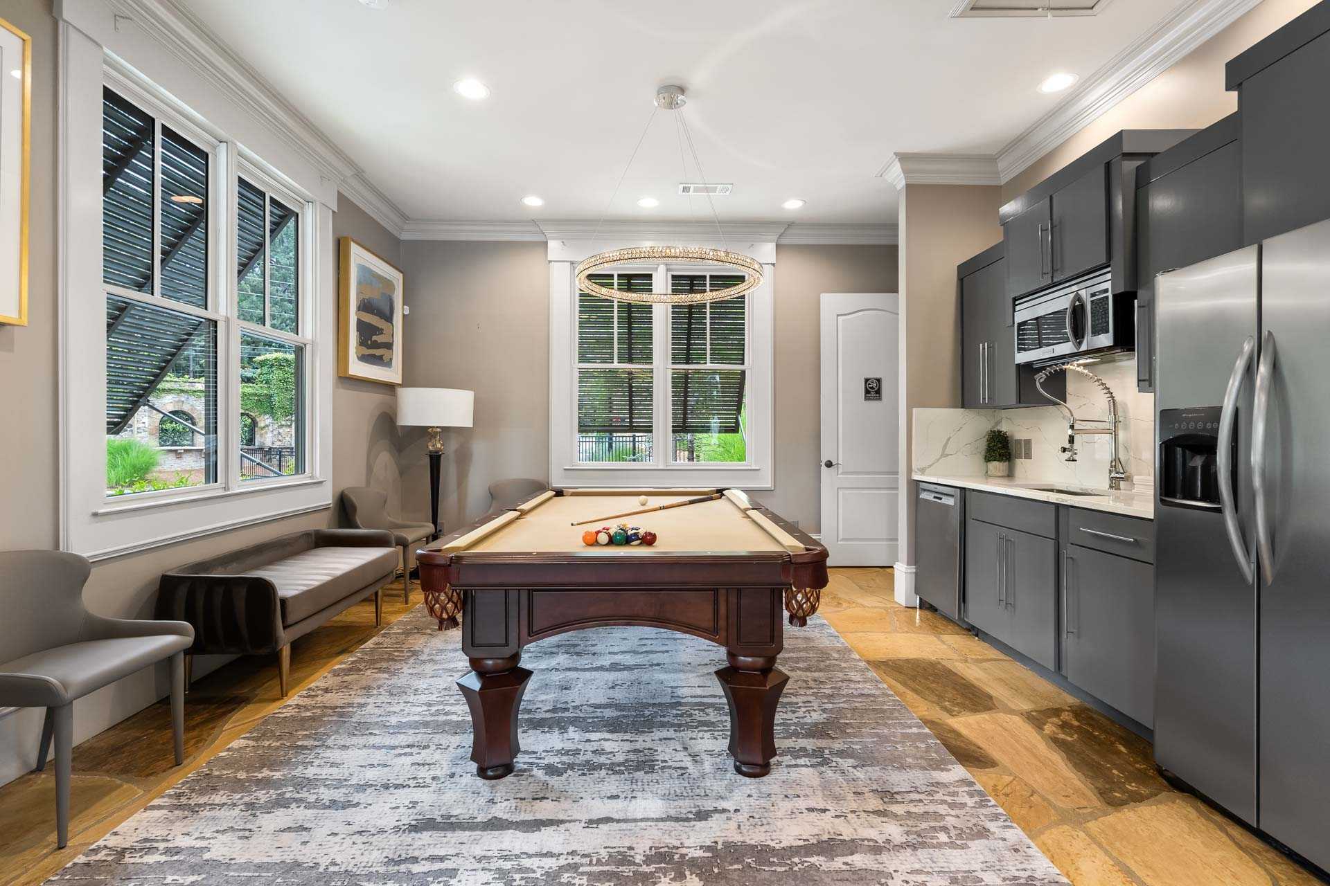 Billiards room at The Village at Towne Lake in Woodstock GA with pool table, kitchenette, and large windows