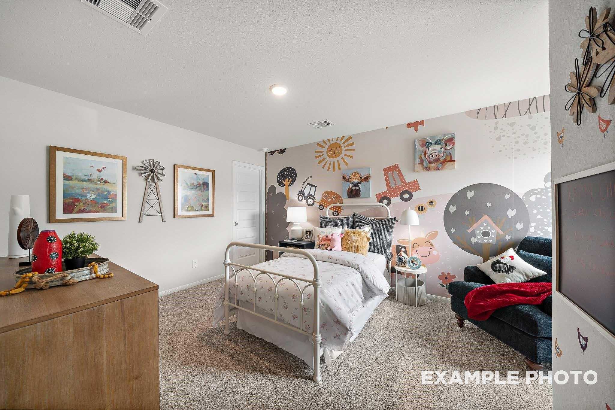 Charming kids' bedroom with colorful vehicle and animal mural, white twin bed, wooden dresser in Davidson Homes The San Marcos E, Conroe, Texas