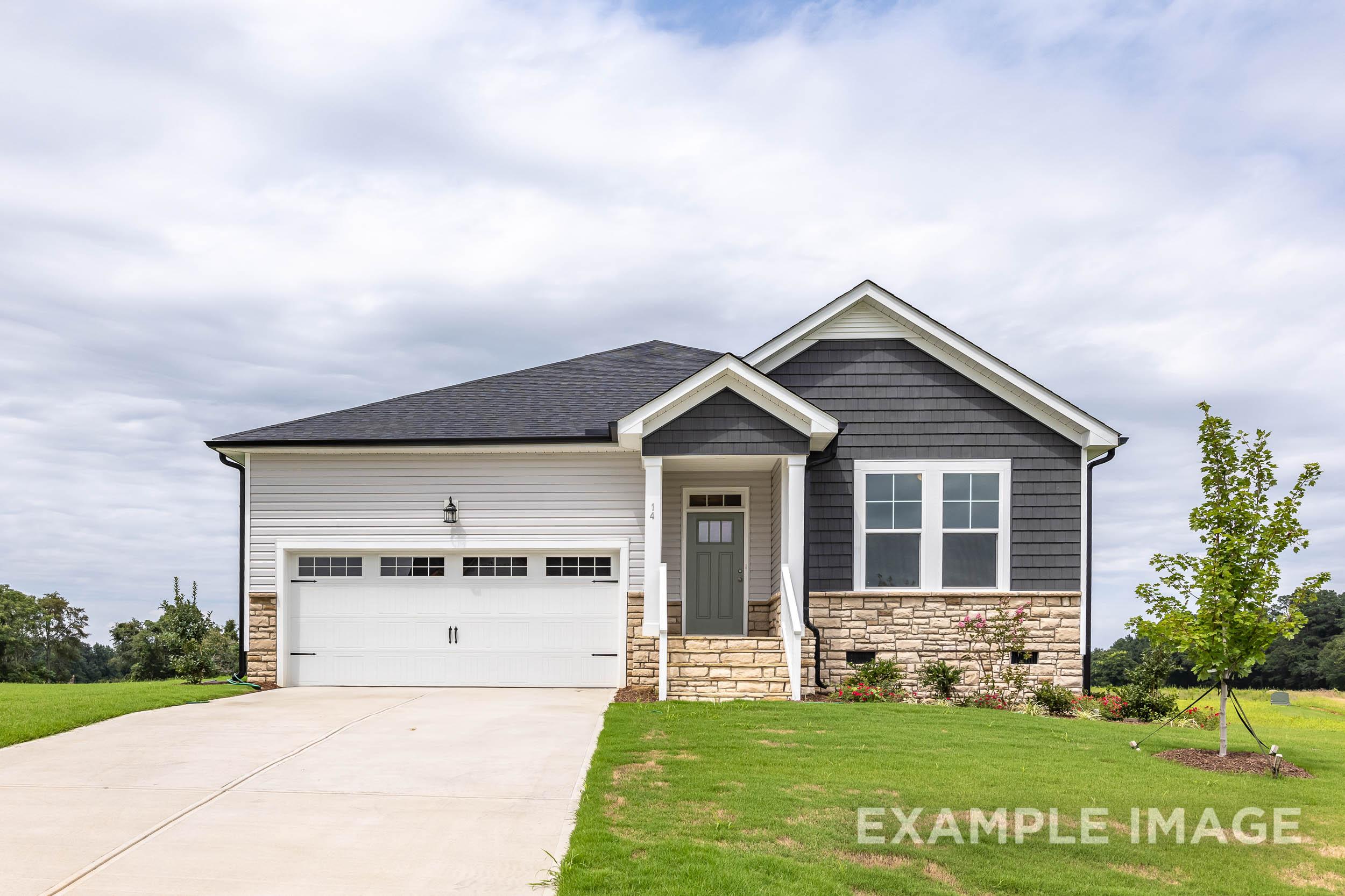 Modern single-story The Daphne C home elevation with gray siding, stone accents, covered porch, and 2-car garage in Lillington NC