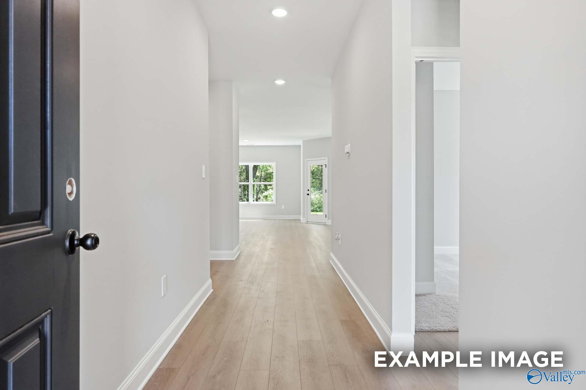 Bright entryway and hallway leading to open floor plan in The Franklin C home at The Highlands in Arab, Alabama.