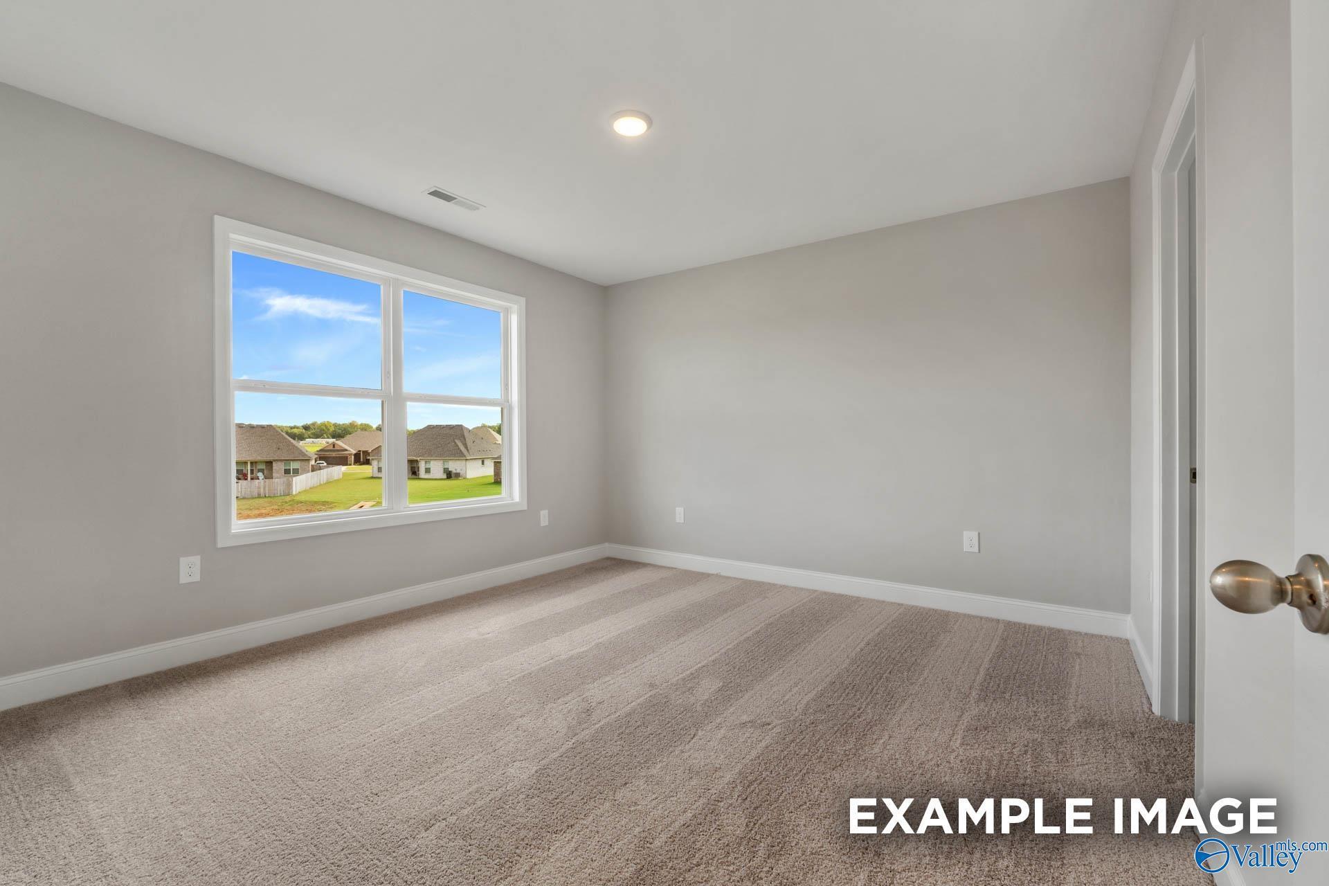 Bright empty bedroom with large window overlooking Heritage Lakes neighborhood in 4-bedroom Shelby B home, New Market, Alabama
