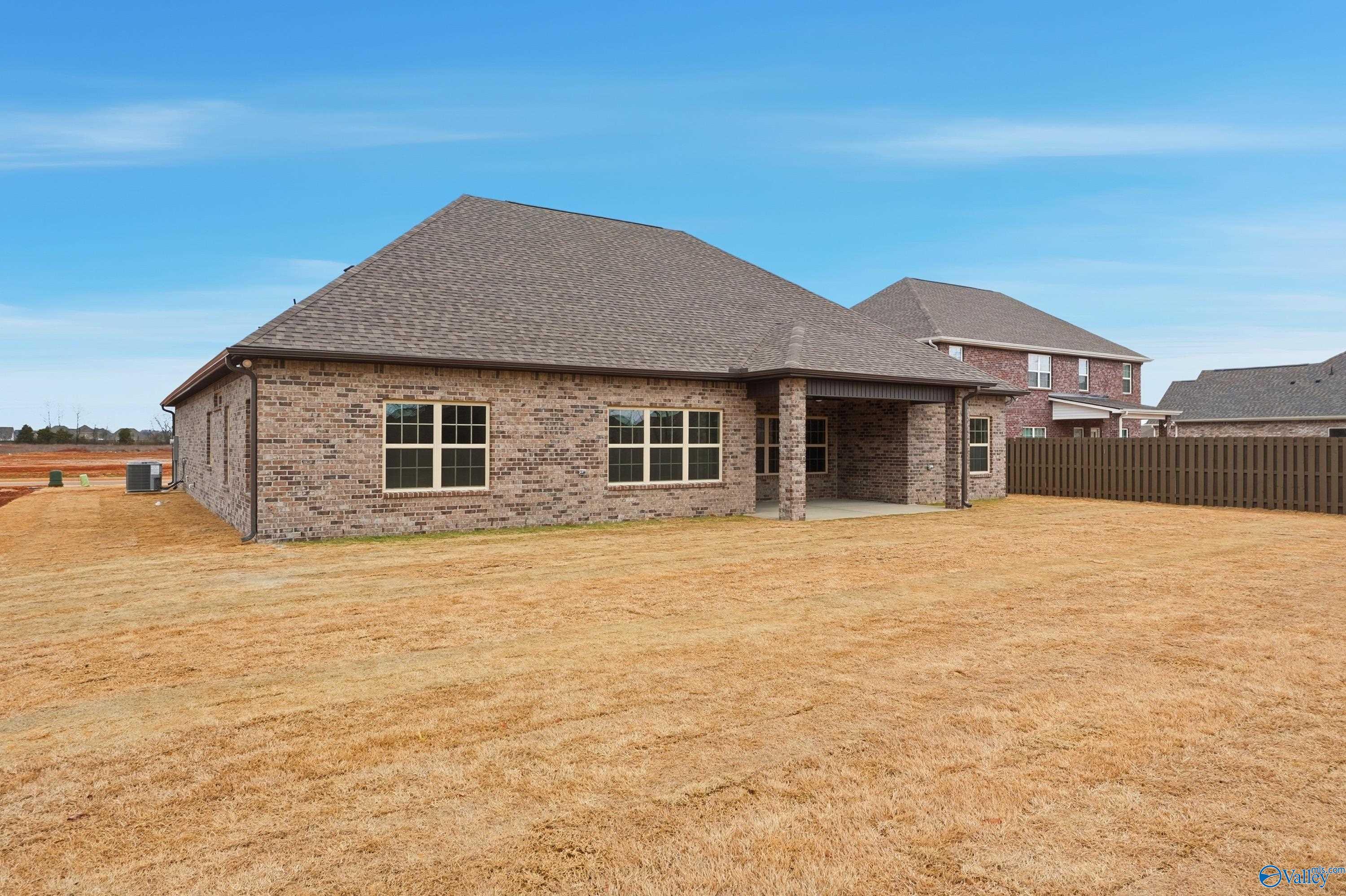 Single-story brick Finleigh home with covered porch, fenced backyard, and adjacent homes in Briercreek, Meridianville, Alabama