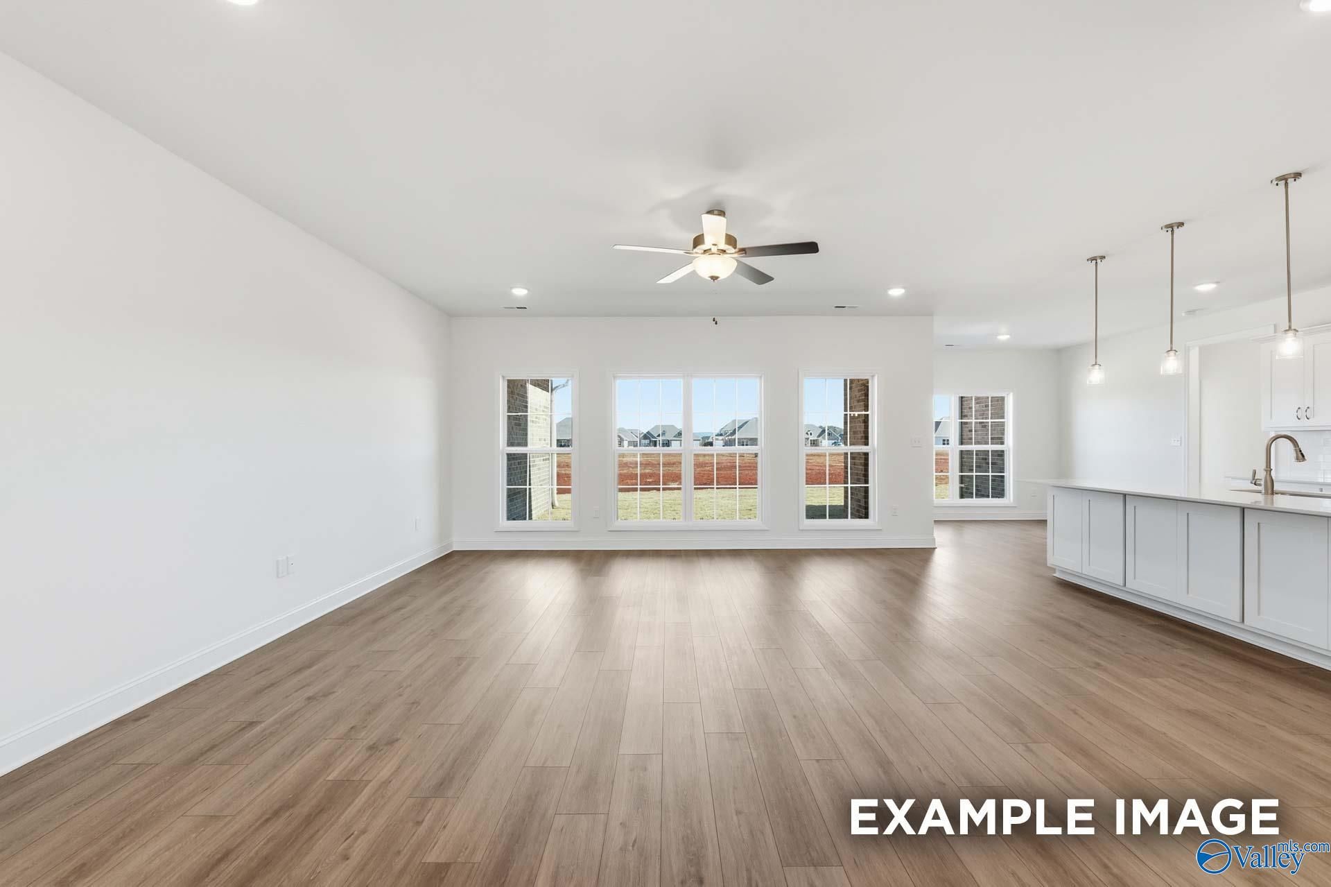 Open-concept living room and kitchen in The Valencia floor plan by Davidson Homes in Briercreek, Meridianville, Alabama.
