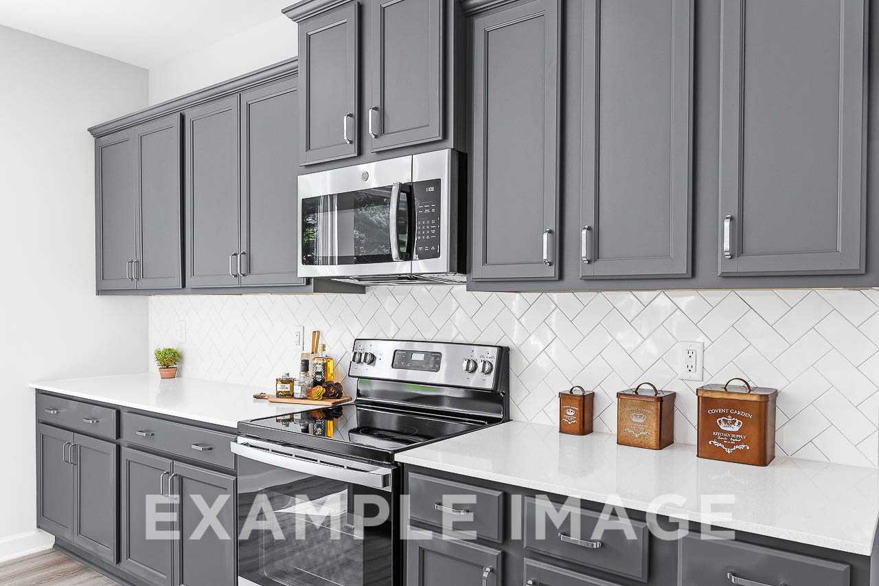 Davidson Homes The Chestnut Plan Kitchen with Microwave, oven, and grey painted cabinetry