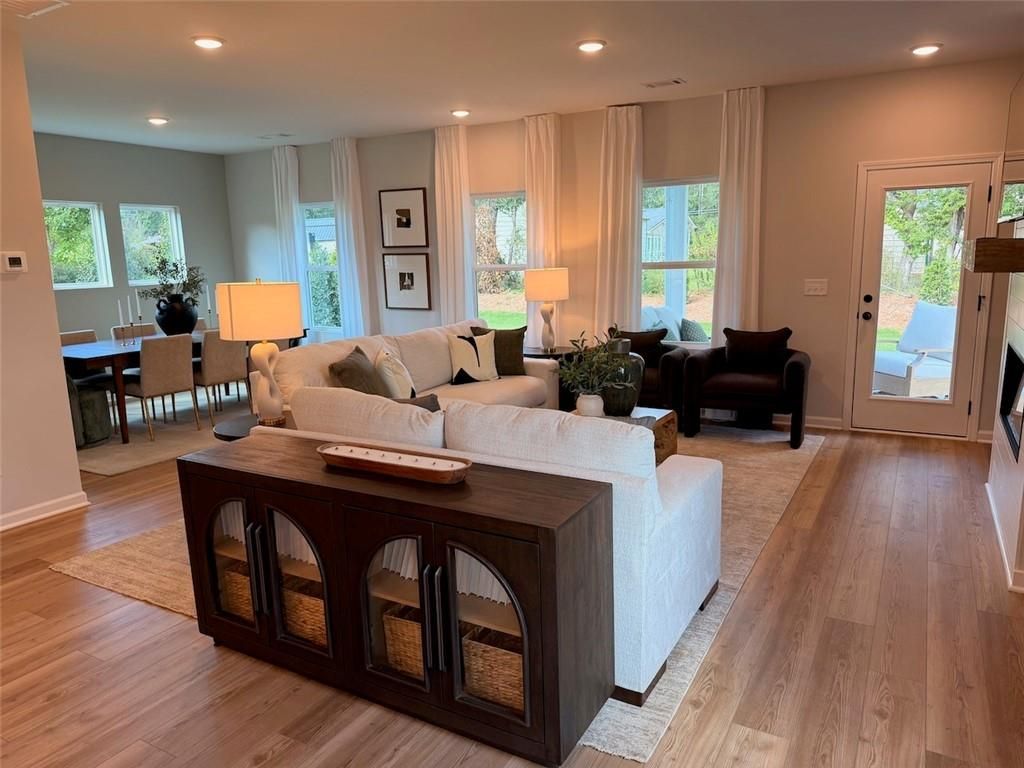 Bright open-concept living room with sectional sofa and hardwood floors in Davidson Homes' The Pinecrest J, Greene Farm, Cartersville, GA