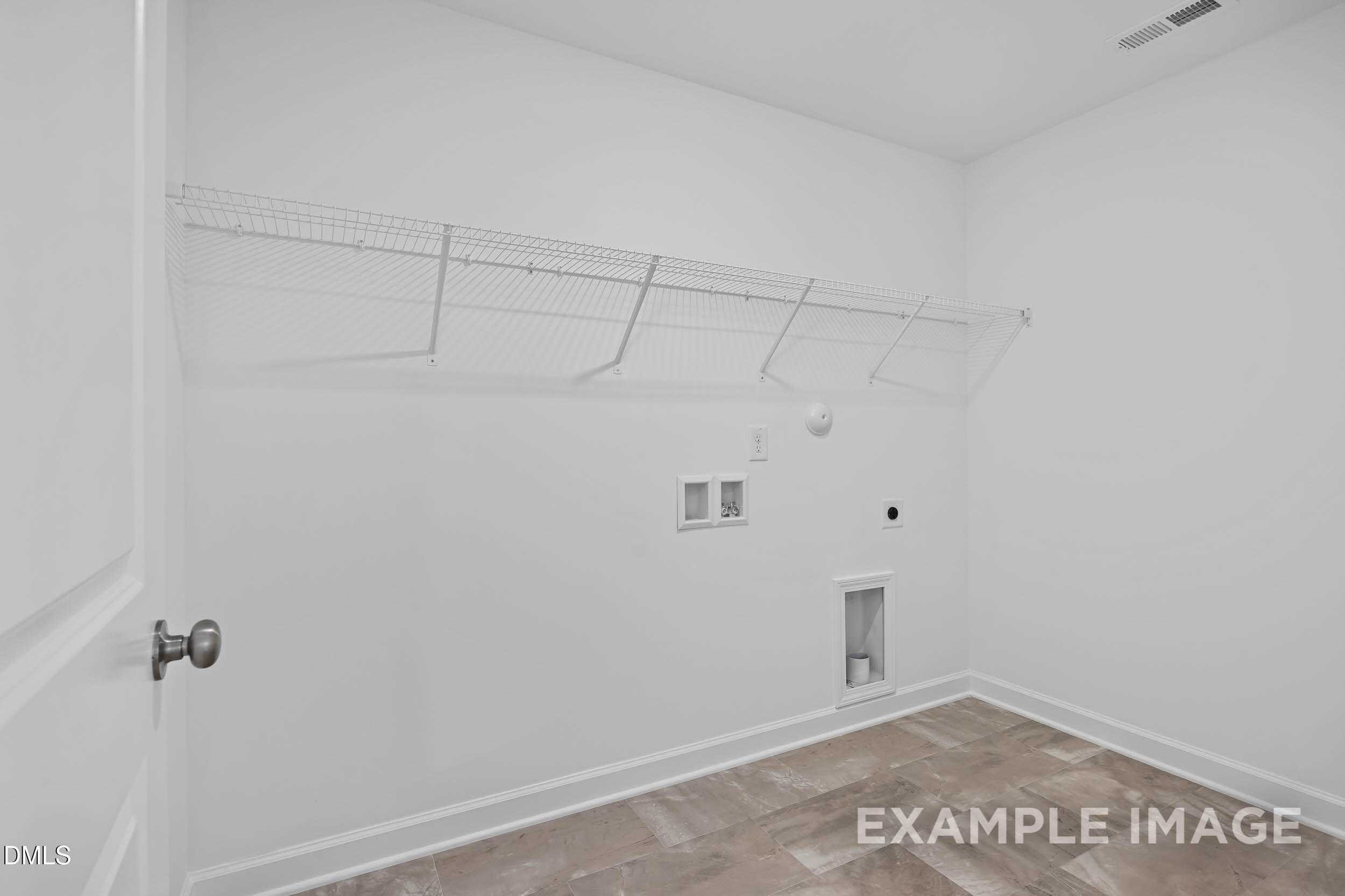 Spacious laundry room with wire shelving, utility sink and washer-dryer hookups in Davidson Homes The Willow D, Zebulon, NC