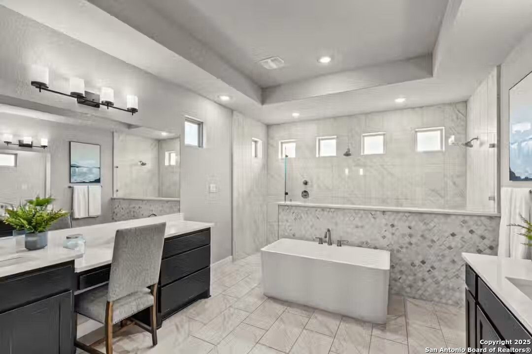 Elegant master bathroom with freestanding tub, double vanity, and tiled shower in Davidson Homes The Summerlin B, Castroville, Texas