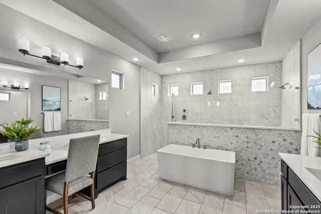 Elegant master bathroom with freestanding tub, double vanity, and tiled shower in Davidson Homes The Summerlin B, Castroville, Texas