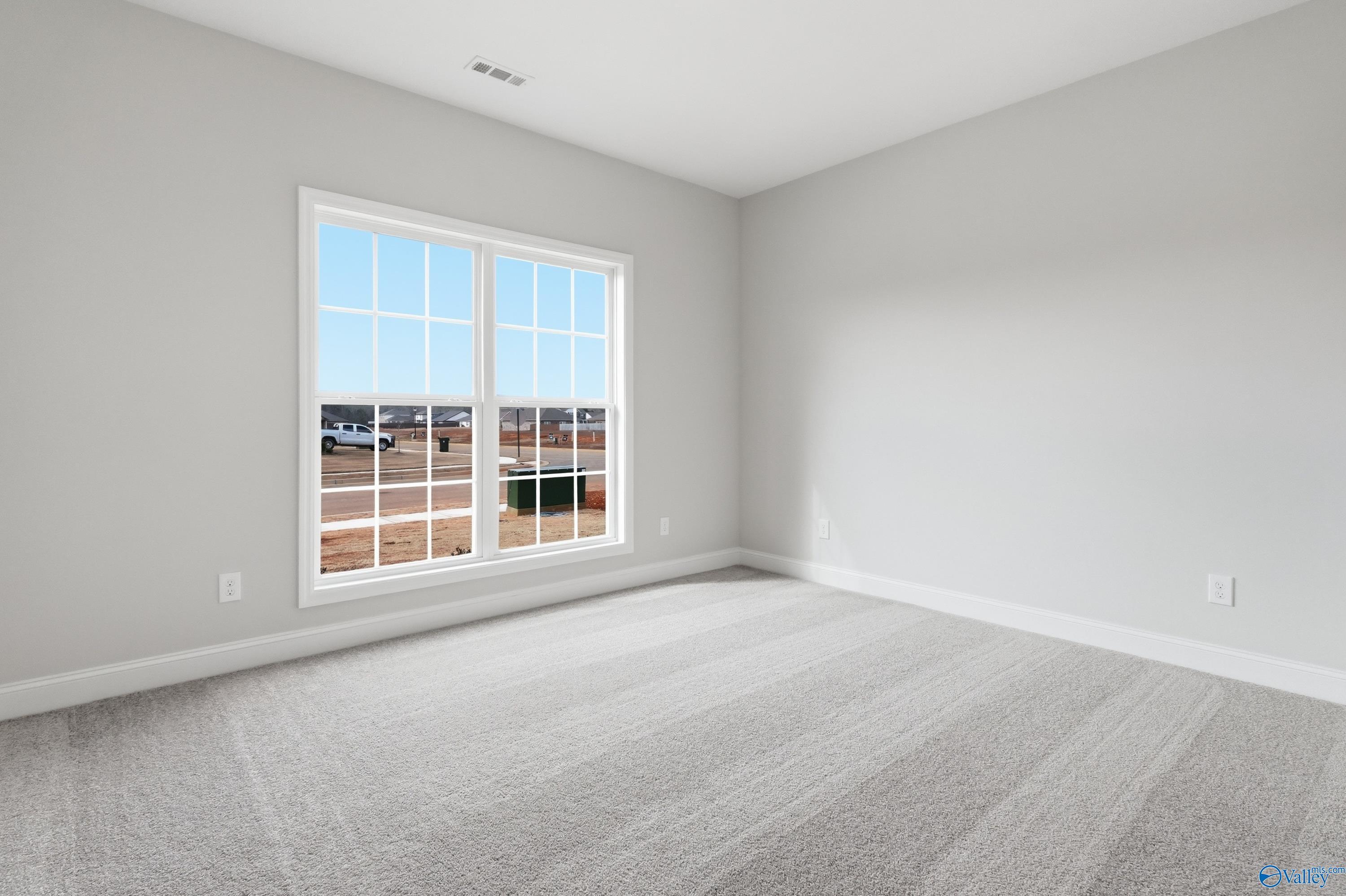 Bright secondary bedroom with large window overlooking neighborhood in Davidson Homes The Daphne C, Toney, Alabama