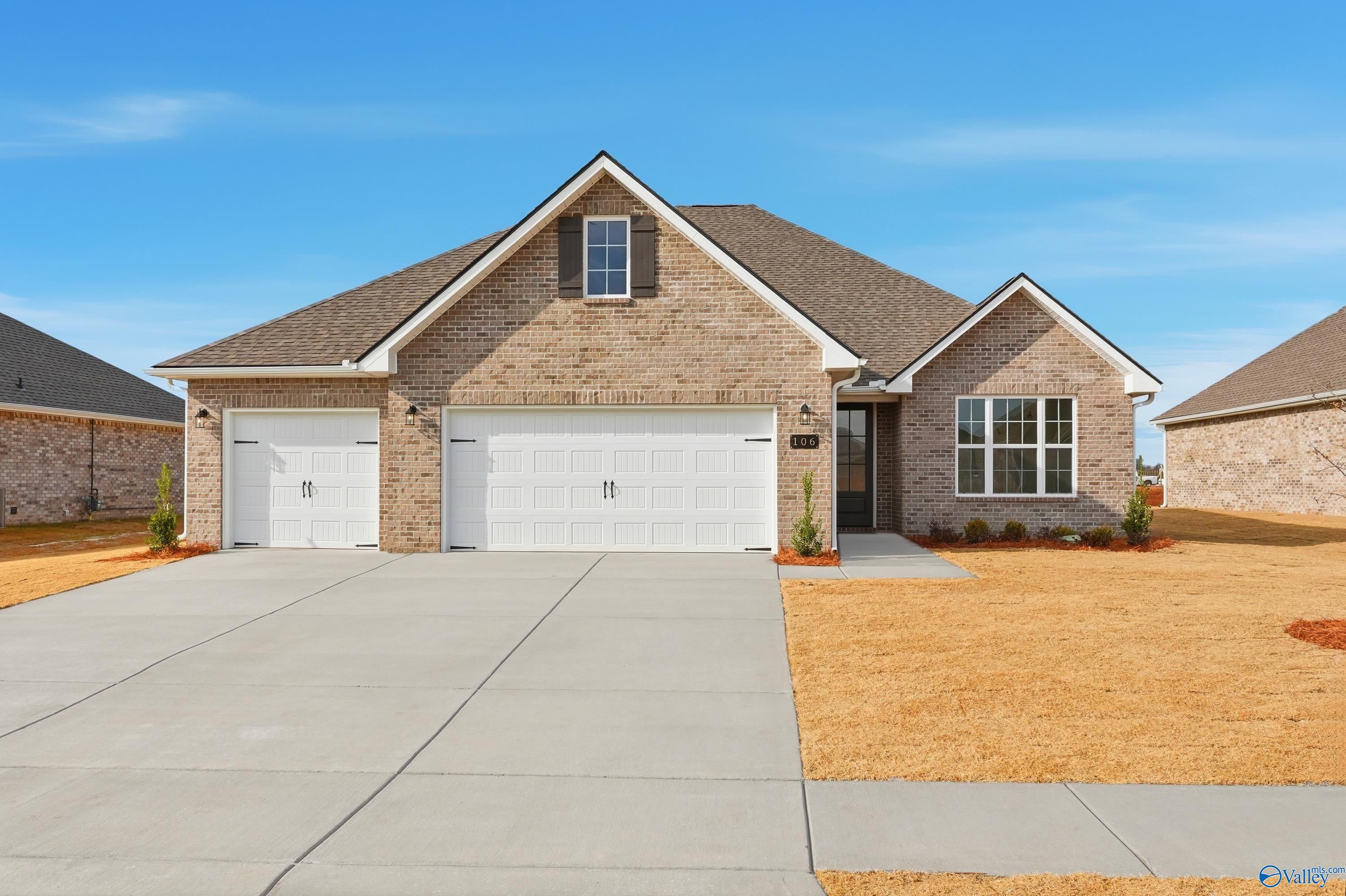Modern single-story brick home with 3-car garage, gabled roof, and driveway in Pikes Ridge, Meridianville, Alabama - Davidson Homes The Lanier
