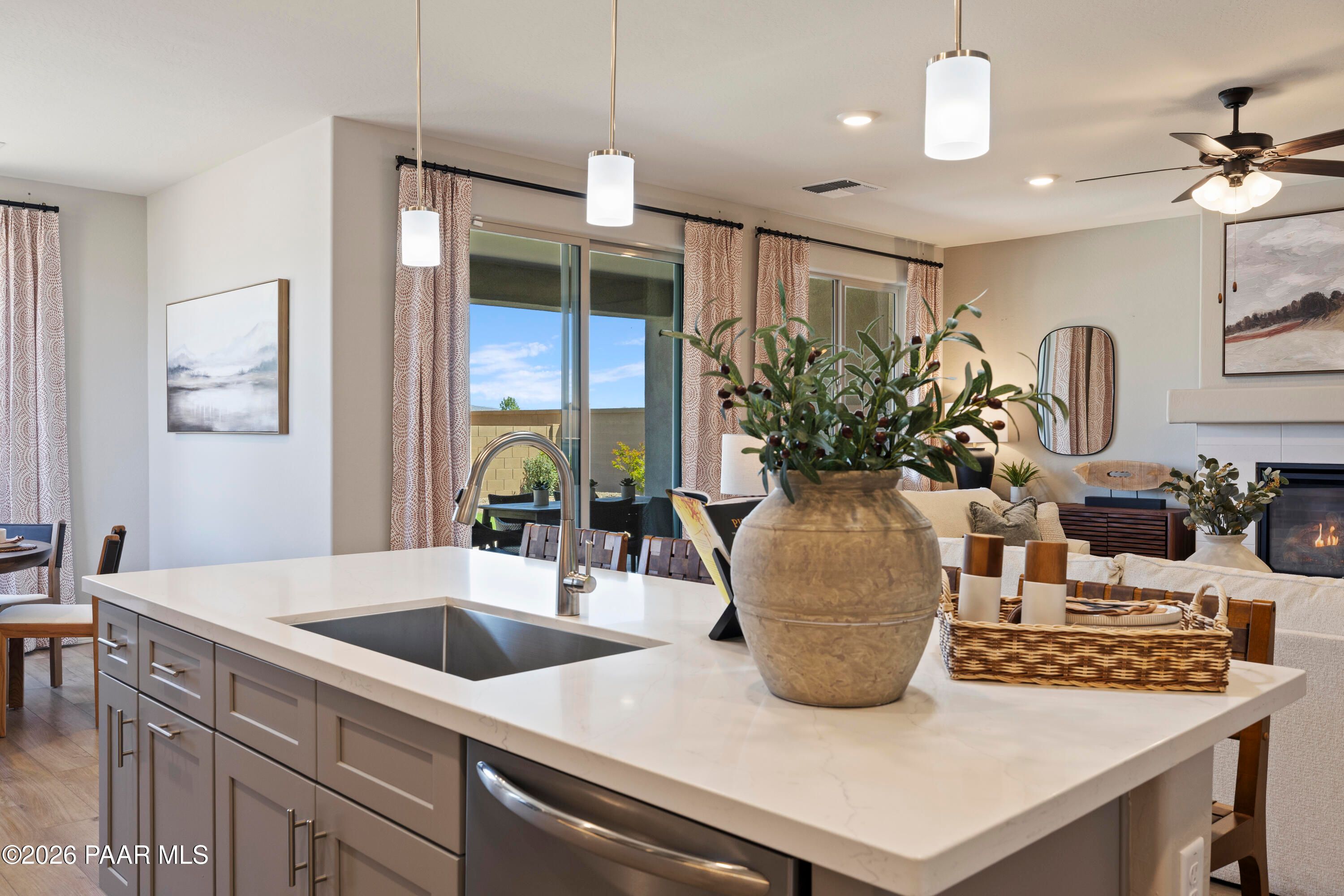 Open-concept kitchen island with quartz countertops in The Harmony A floor plan at Pronghorn Ranch, Prescott Valley.