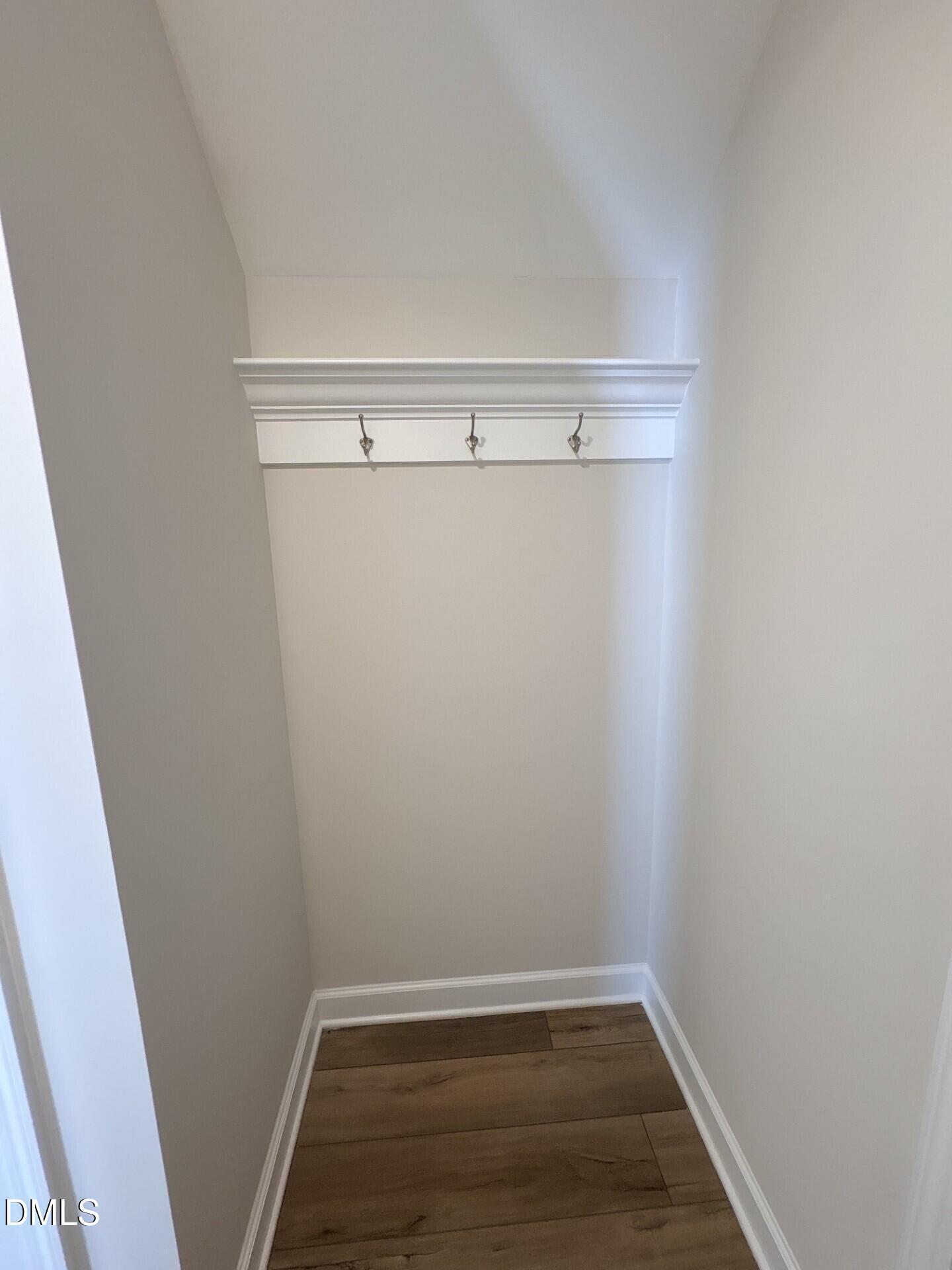 Built-in mudroom coat rack with shelf in The Ash C floor plan at Woodland Crossing, Zebulon, North Carolina.