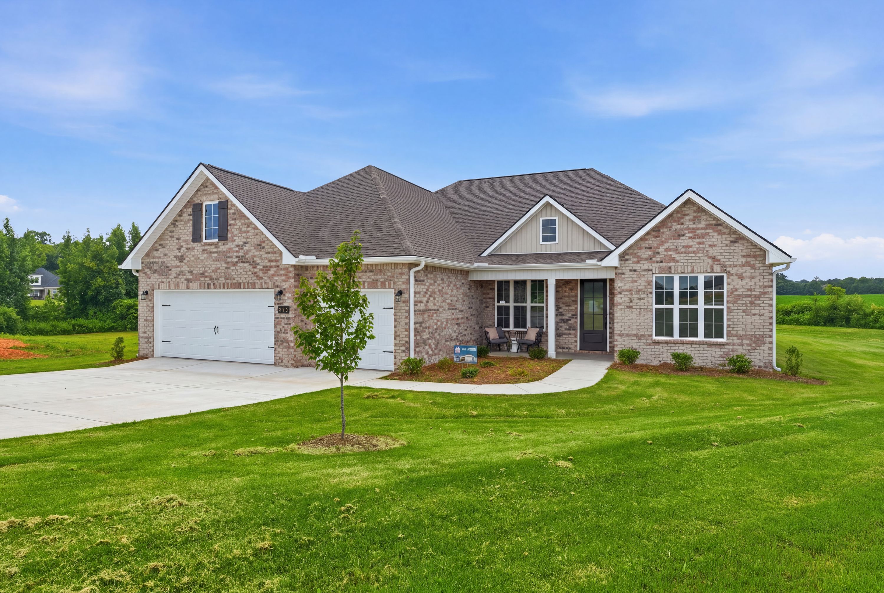 Single-story brick home exterior at Riverton Preserve in Huntsville, Alabama, built by Davidson Homes with a two-car garage.