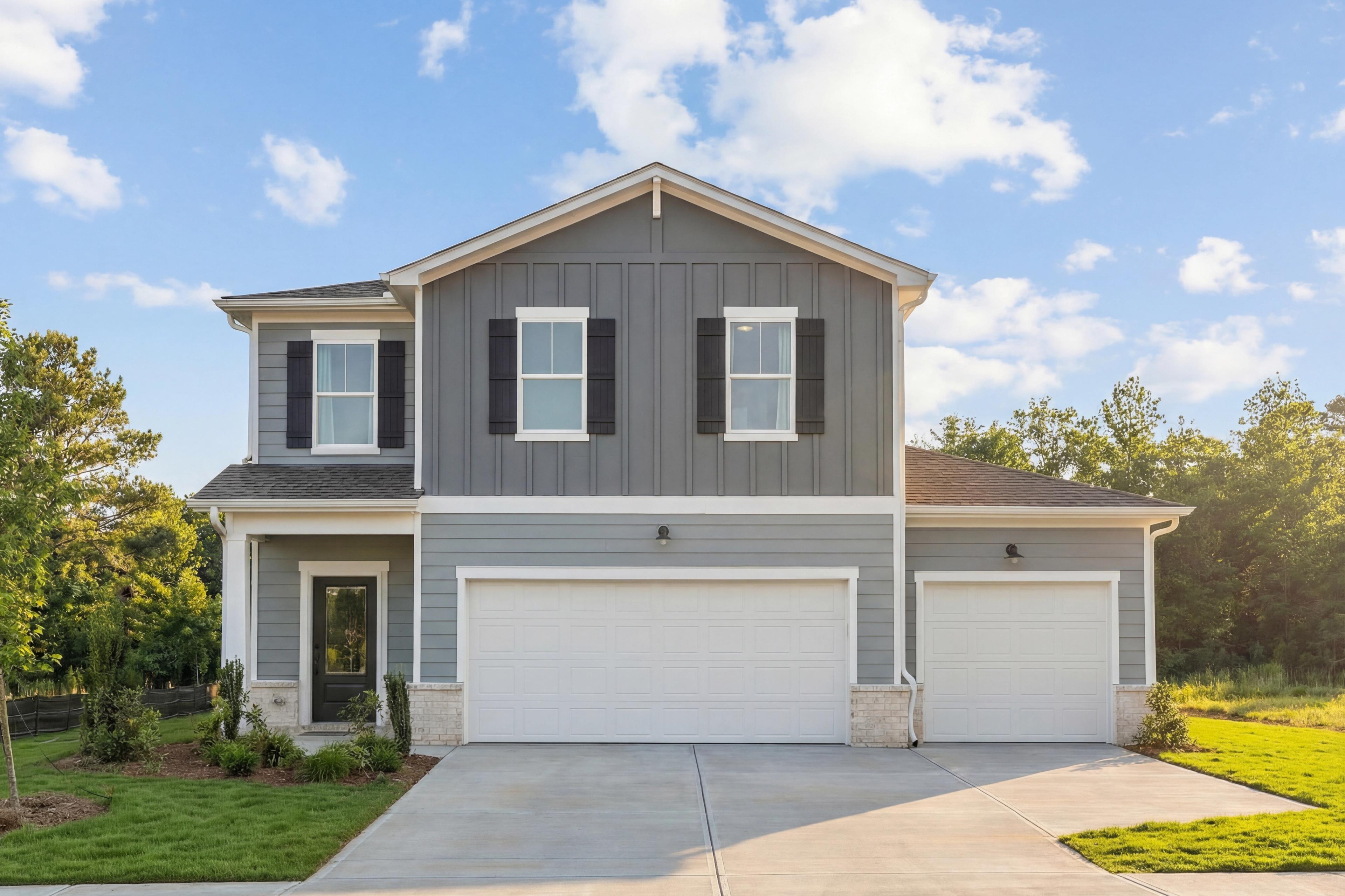 Modern two-story gray home exterior at Cedar Farms in Winder Georgia with covered entry and attached garage