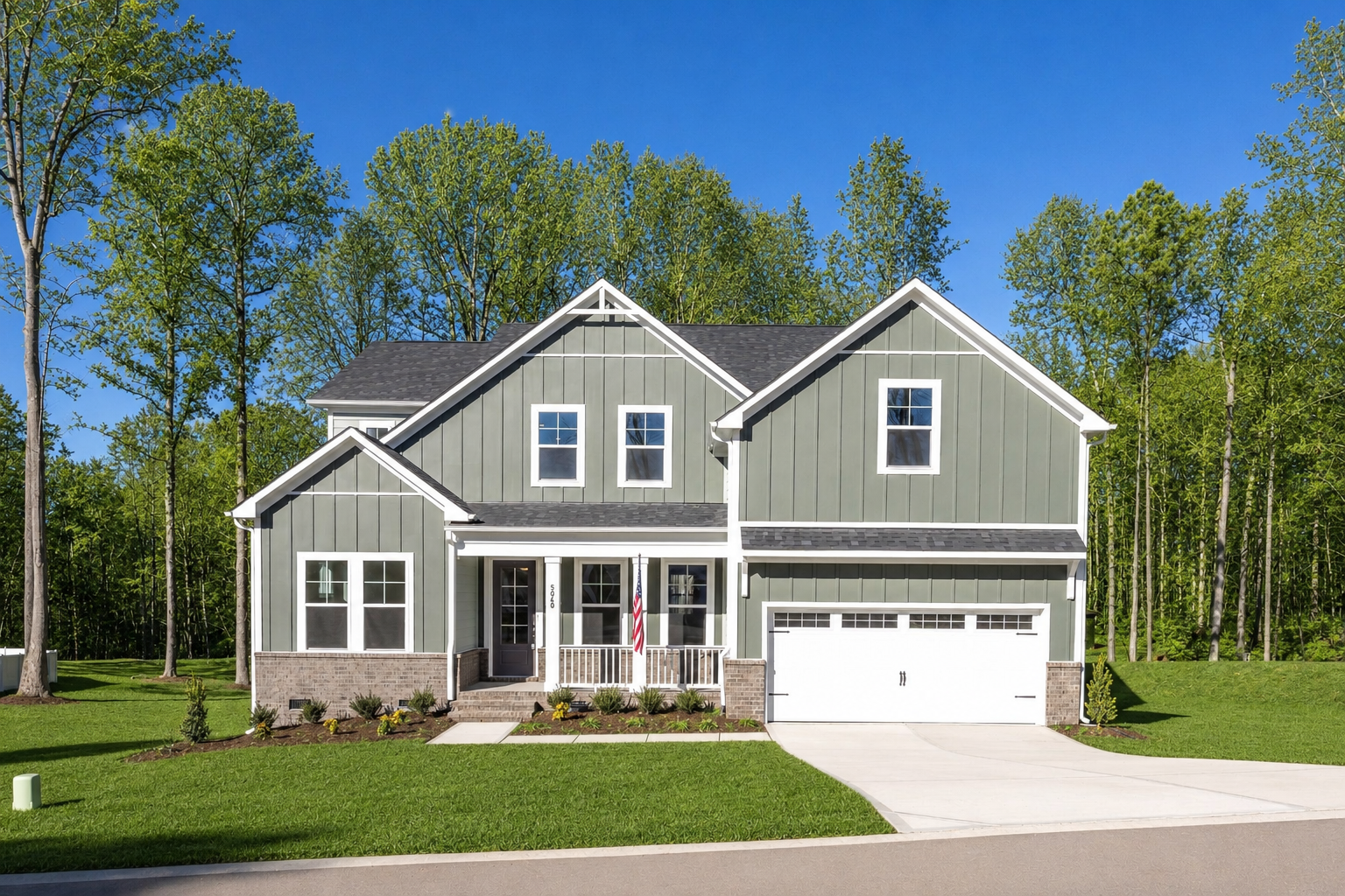 Two-story gray farmhouse exterior at Addison West in Holly Springs, NC, built by Davidson Homes with a two-car garage.