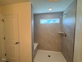 Modern walk-in shower with tiled walls in The Willow B floor plan at Woodland Crossing, Zebulon, North Carolina.