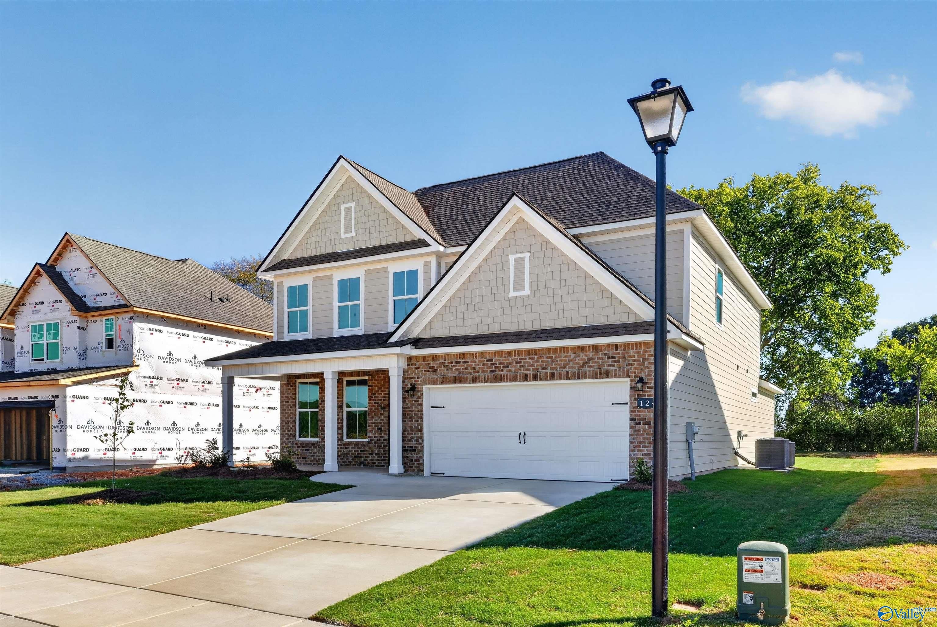 Two-story brick and siding new home with 2-car garage and covered porch in Berry Cove, New Market, Alabama by Davidson Homes