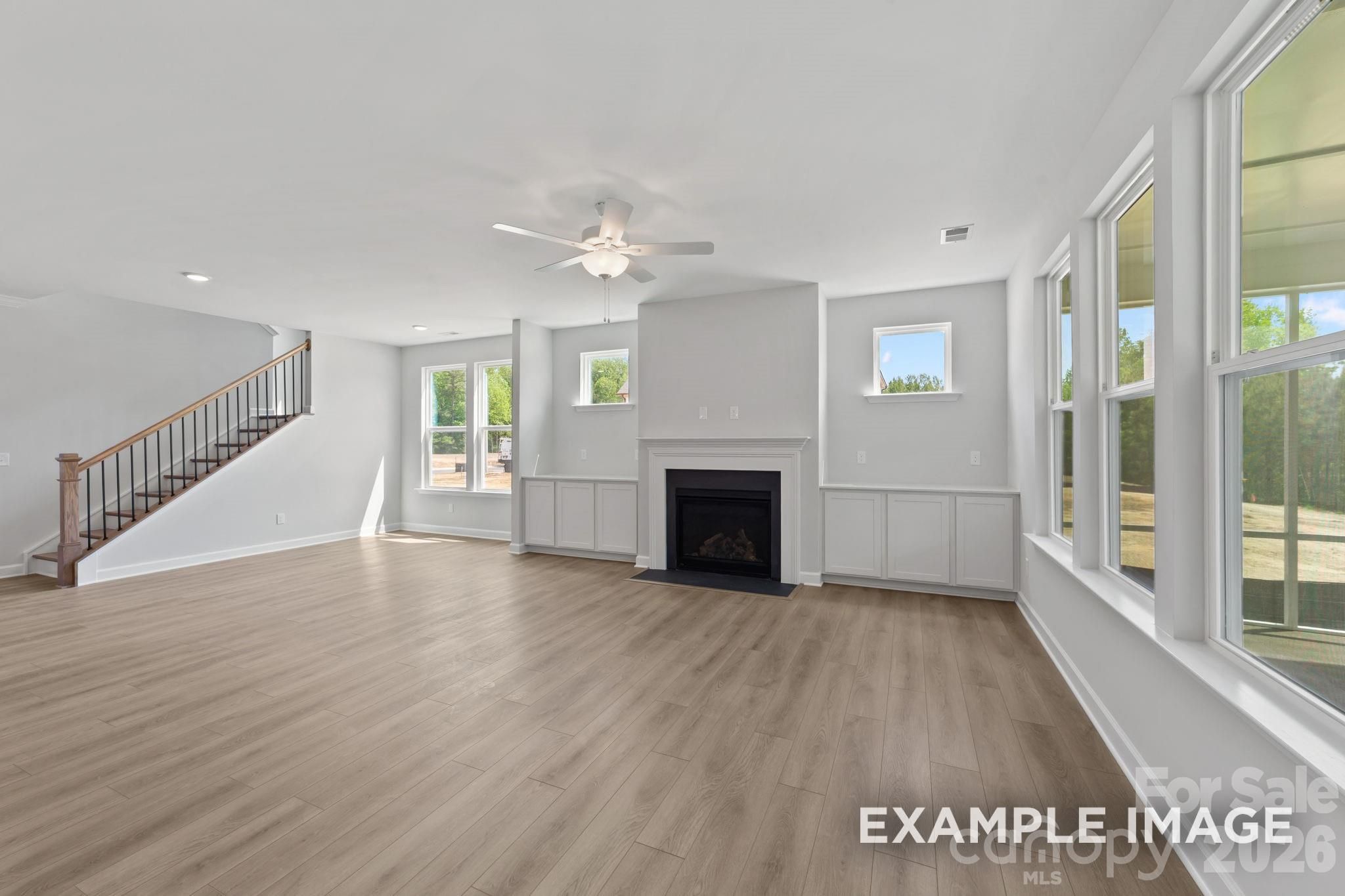 Spacious living room with fireplace and custom built-ins in The Magnolia B floor plan at Windgate, Mooresville, NC.
