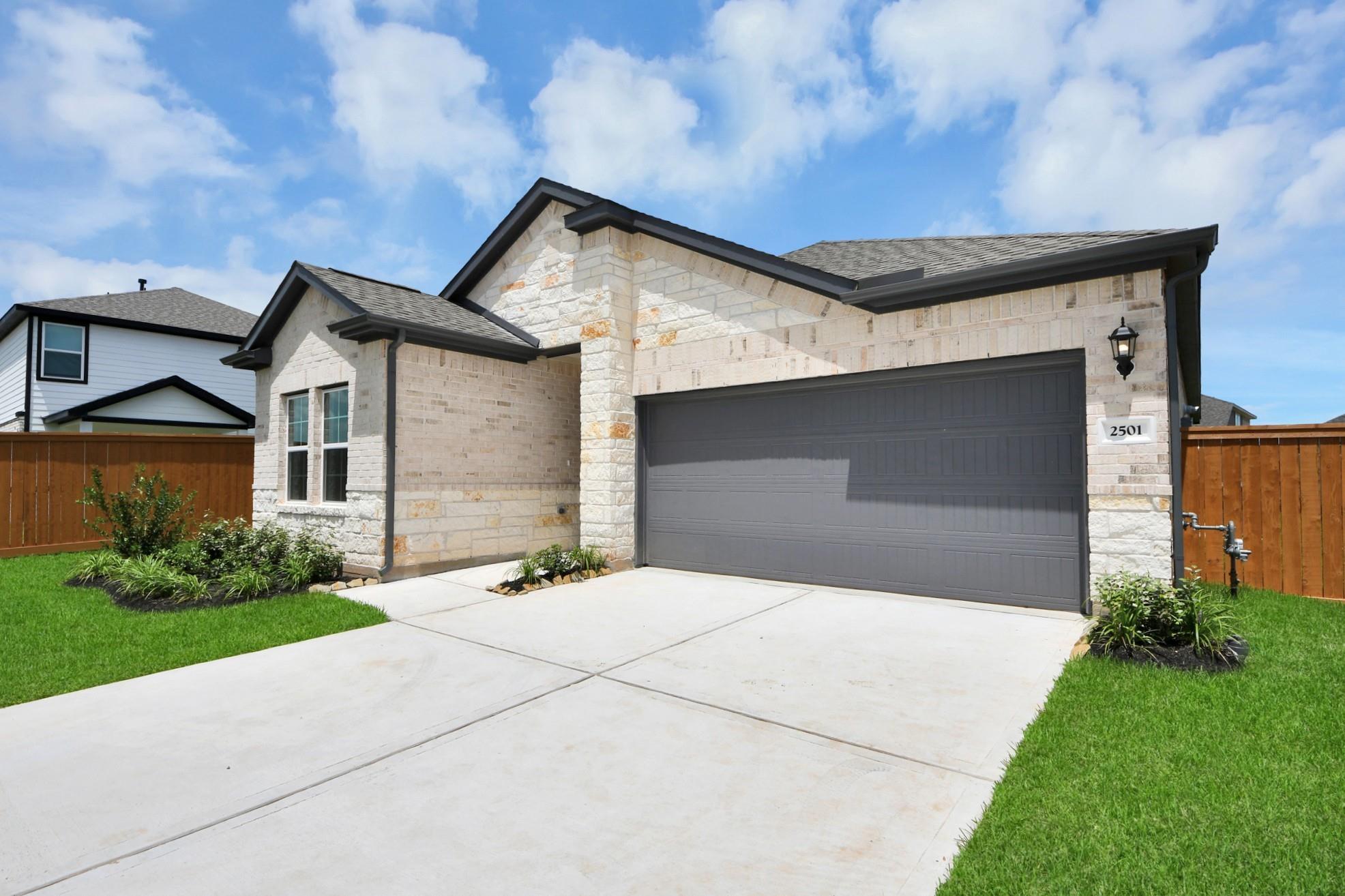Exterior of The Laguna C floor plan by Davidson Homes with a 2-car garage in Sunterra, Katy, Texas.
