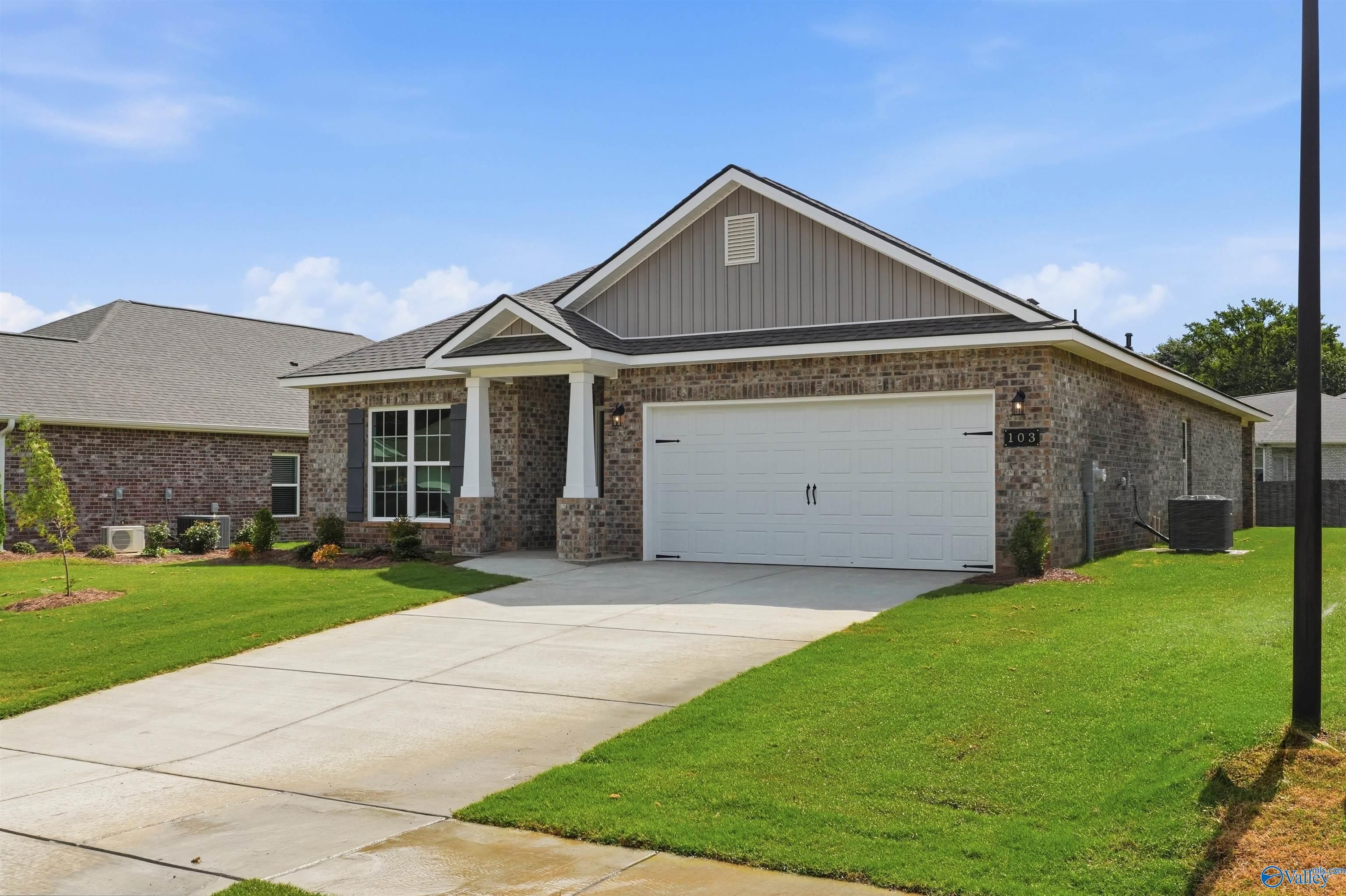 Brick exterior of The Daphne C floor plan by Davidson Homes in Flint Meadows, New Market, Alabama with 2-car garage.