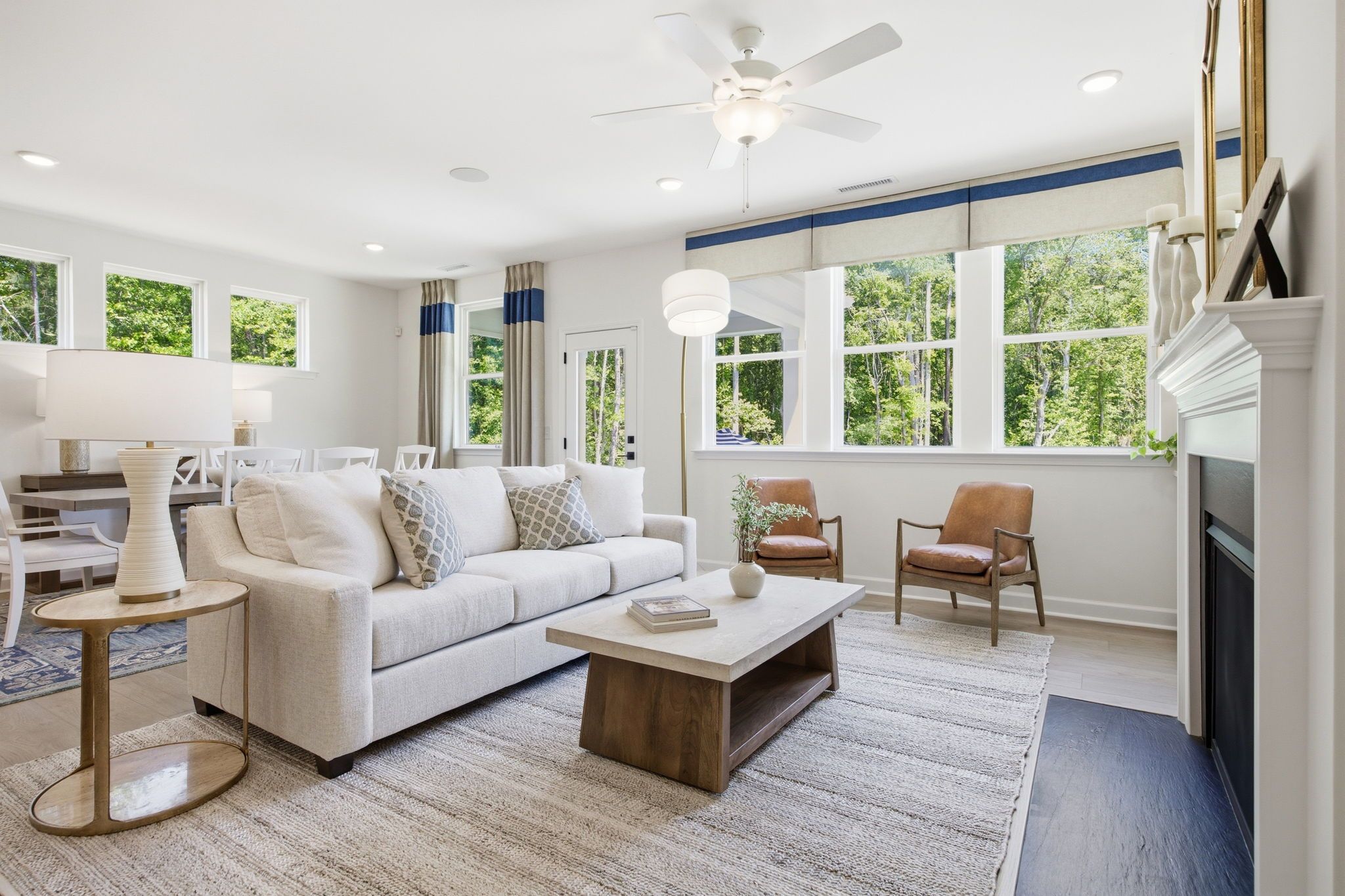 Bright open-concept living room in The Ashport with fireplace, modern furniture, and natural lighting in Wendell, NC.
