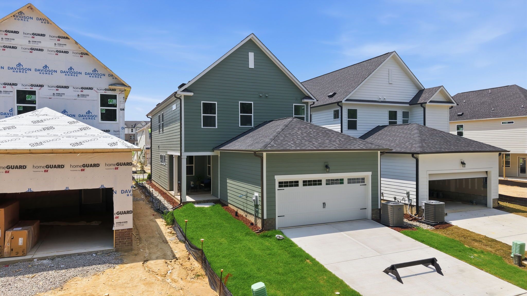 Exterior view of The Jordan A two-story single-family home by Davidson Homes in Knightdale featuring a two-car garage.